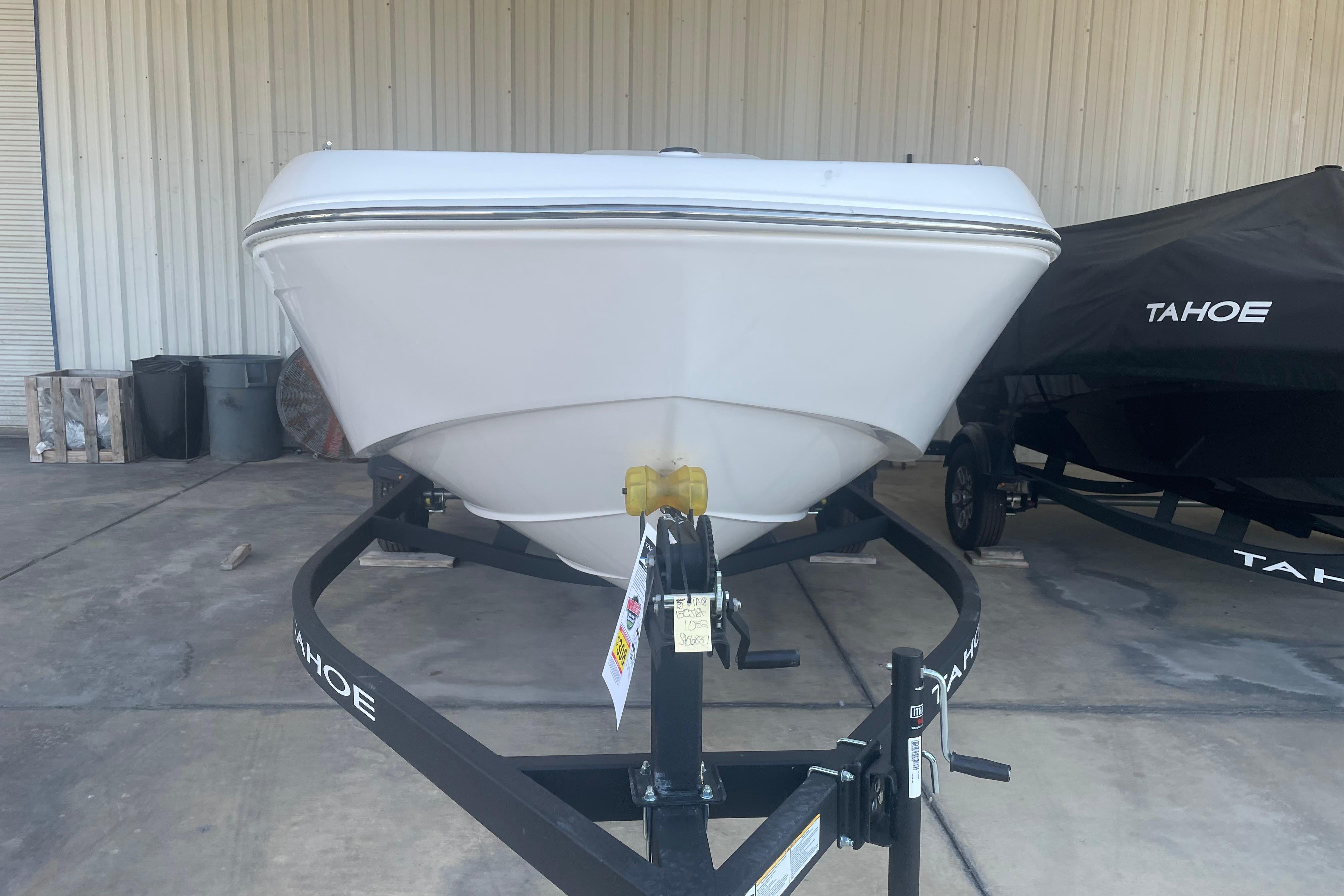 2026 Tahoe T18 boat on trailer in storage facility.