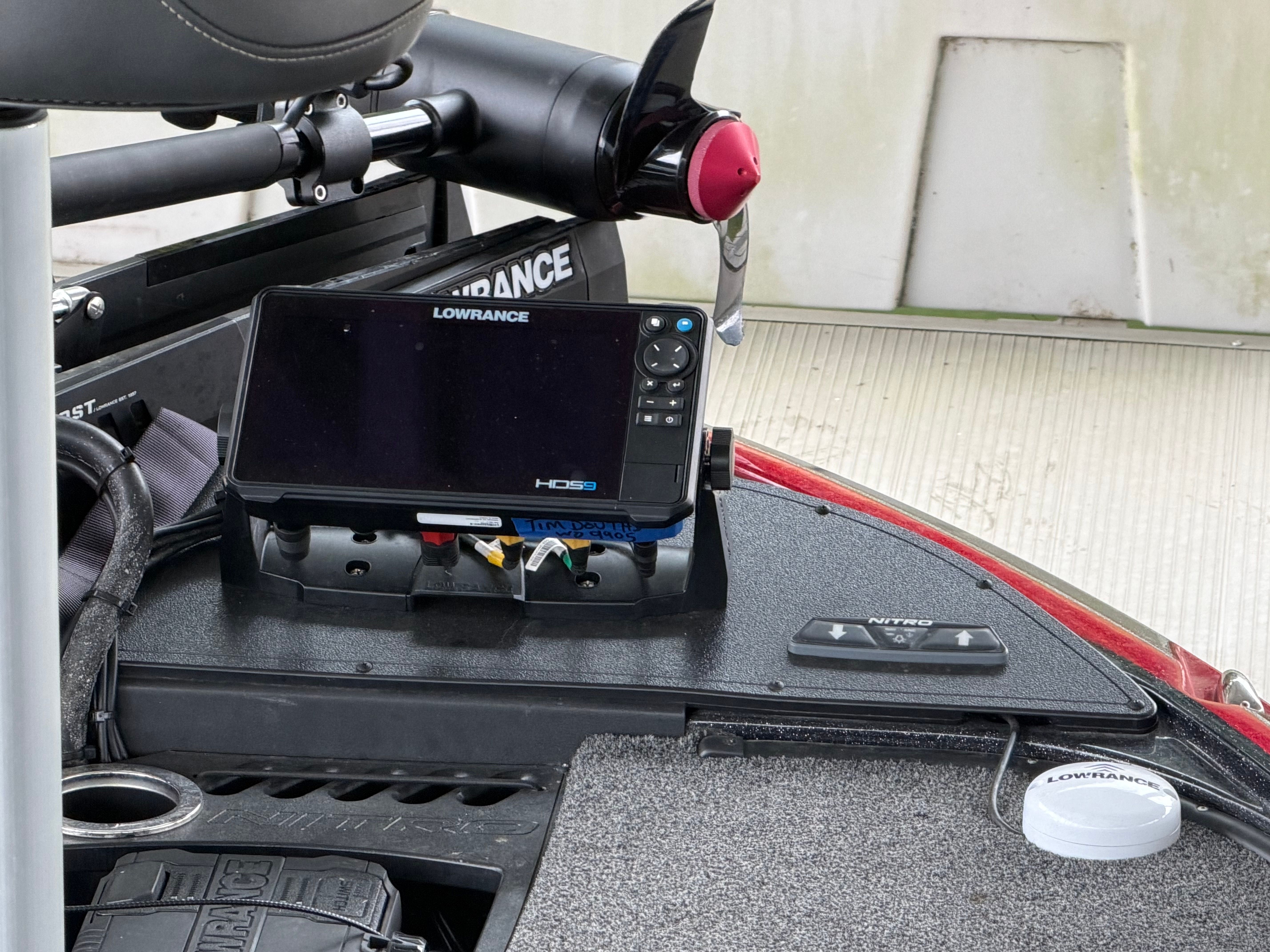 A Lowrance fish finder is mounted on the dashboard of a Tracker Z19 boat.