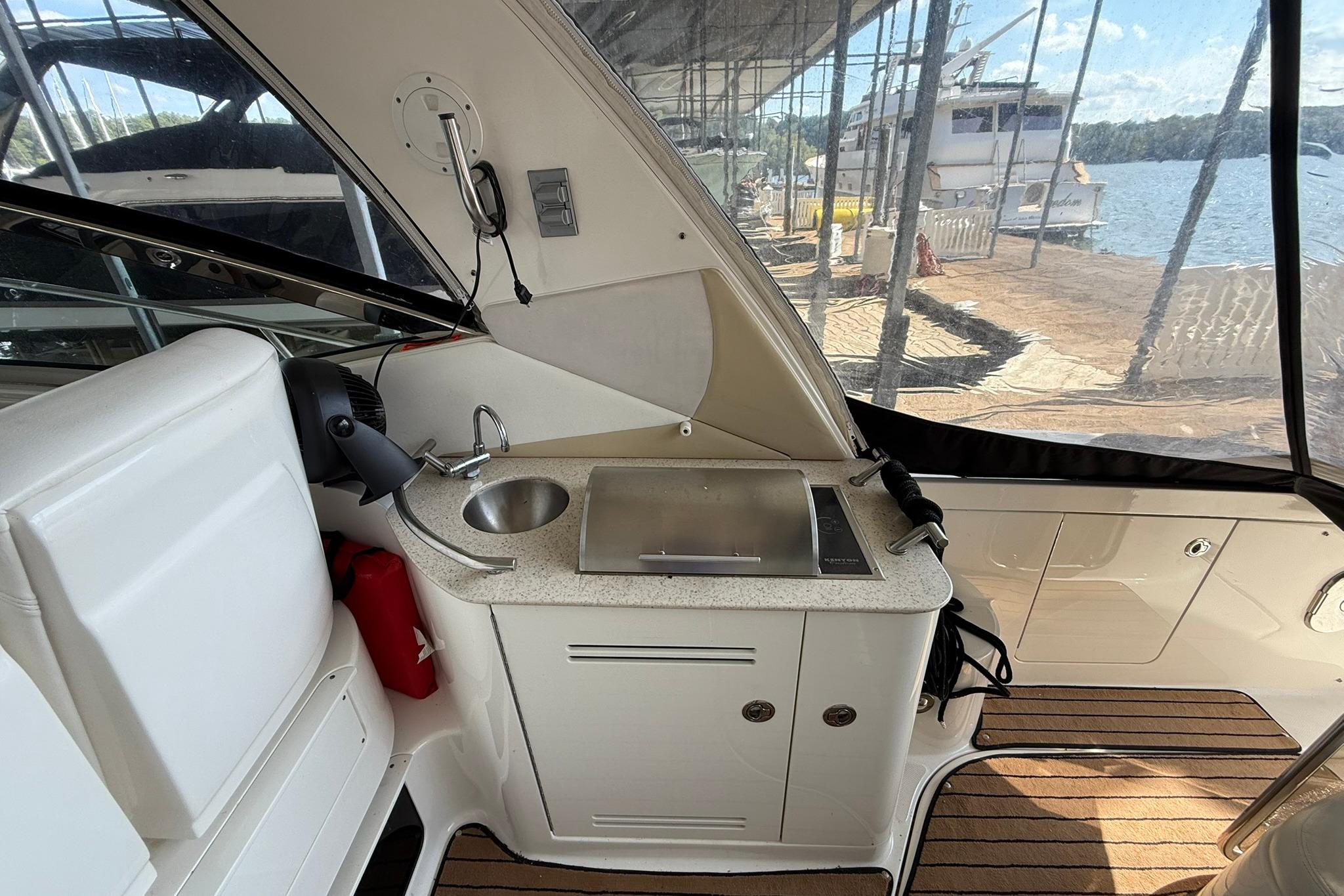 2009 Sea Ray 350 Sundancer boat interior with kitchenette and lake view.