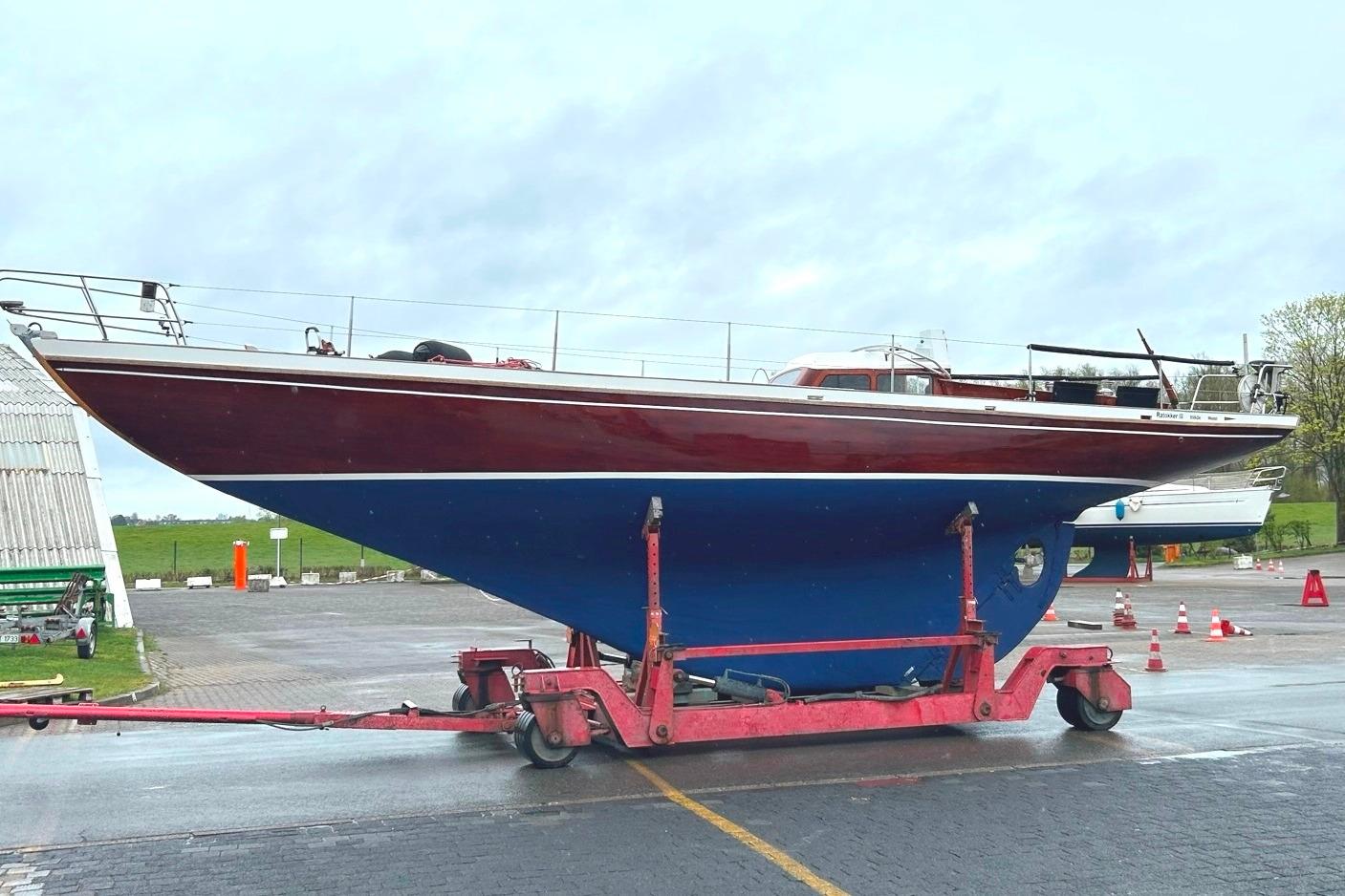 1956 One Off 12m mahogany yacht on trailer, displayed outdoors.
