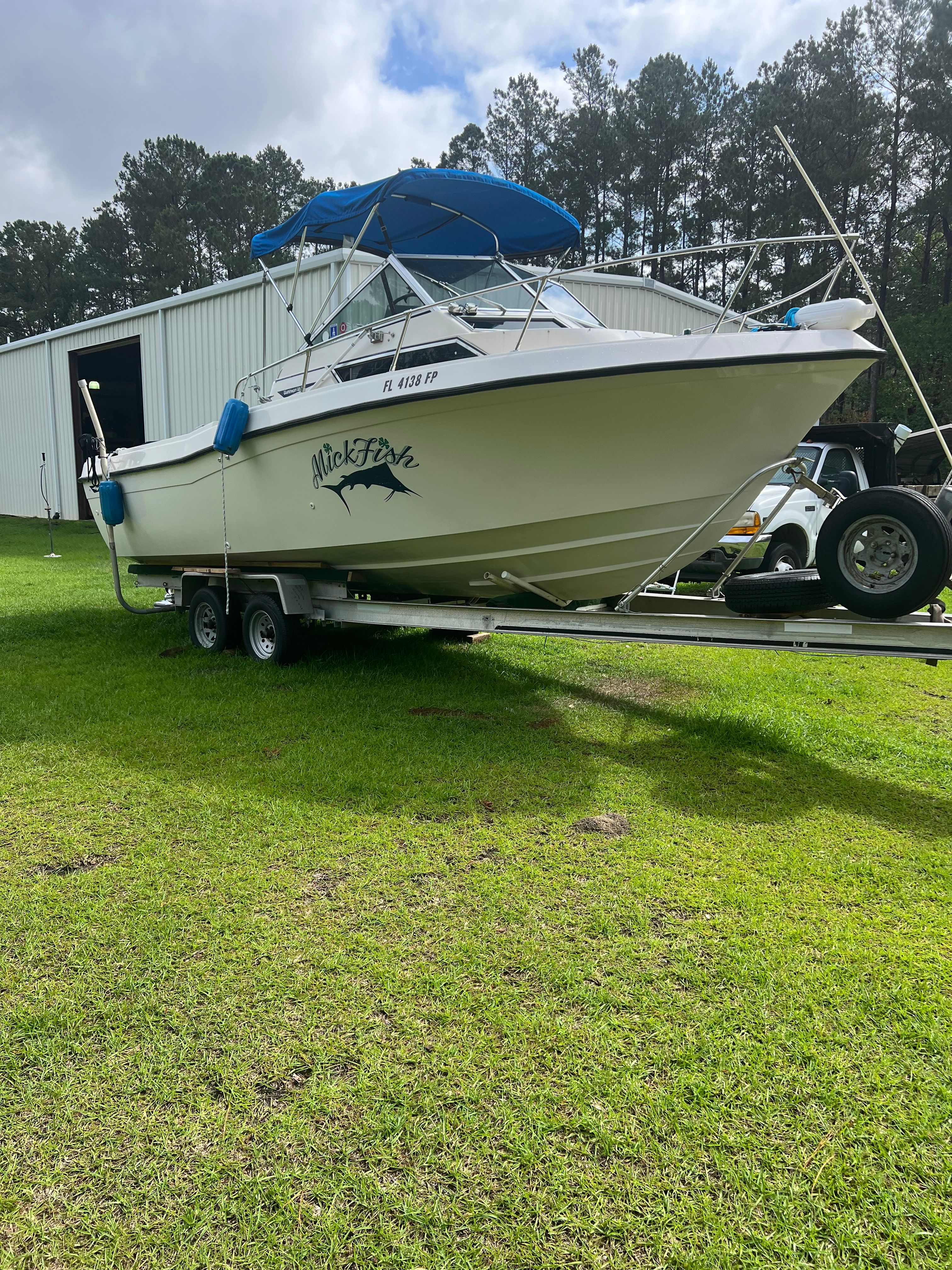 1987 Grady-White Gulfstream boat on trailer, parked outdoors.