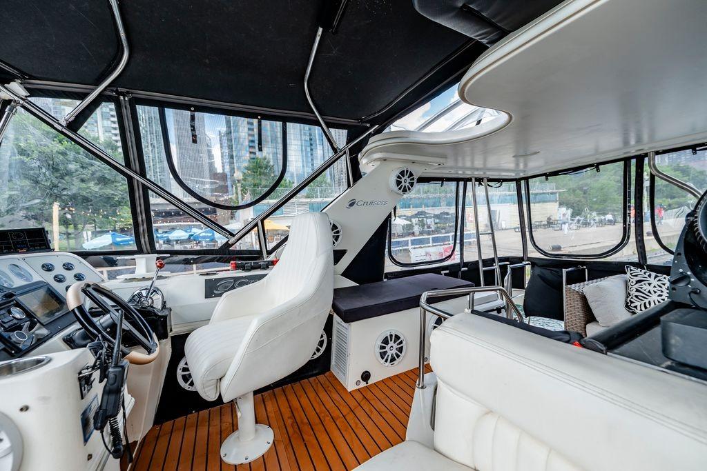 1991 Cruisers Yachts 3850 Aft Cabin interior with helm, seating, and panoramic windows.