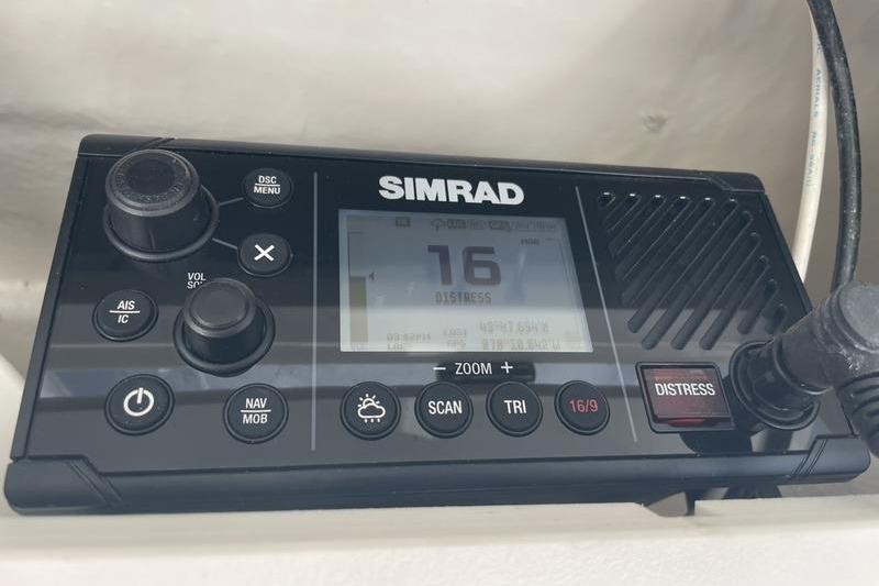 Simrad marine radio on 2023 Robalo R270 Center Console, displaying channel 16 distress signal.