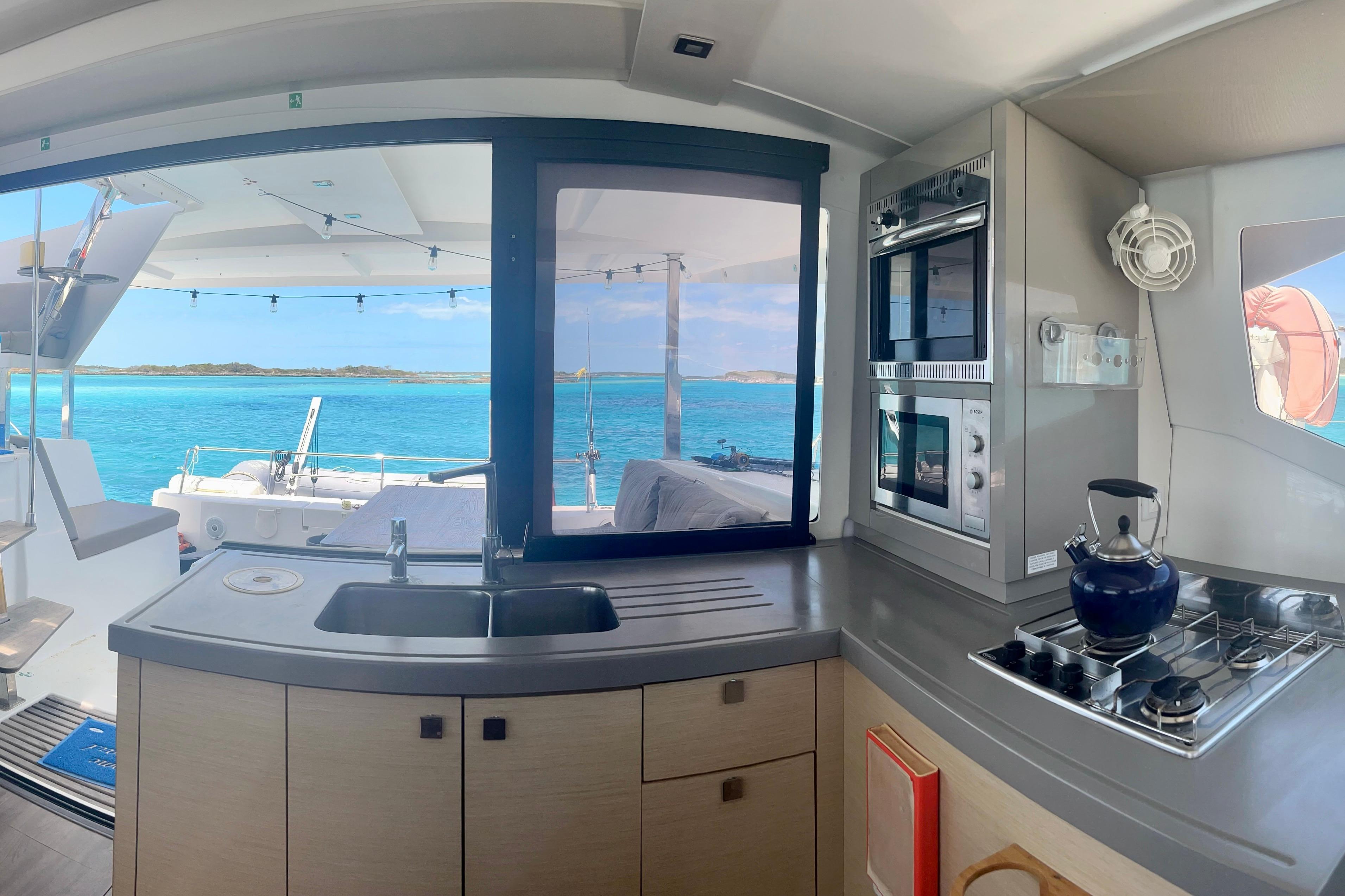 Interior of 2018 Fountaine Pajot Lucia 40 catamaran with ocean view through kitchen window.