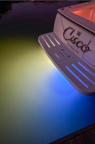 2006 Tiara Yachts 3200 Open with underwater lights illuminating water.