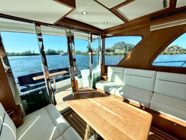 Interior of 2025 Sabre 43 Salon Express yacht with elegant seating and scenic water view.