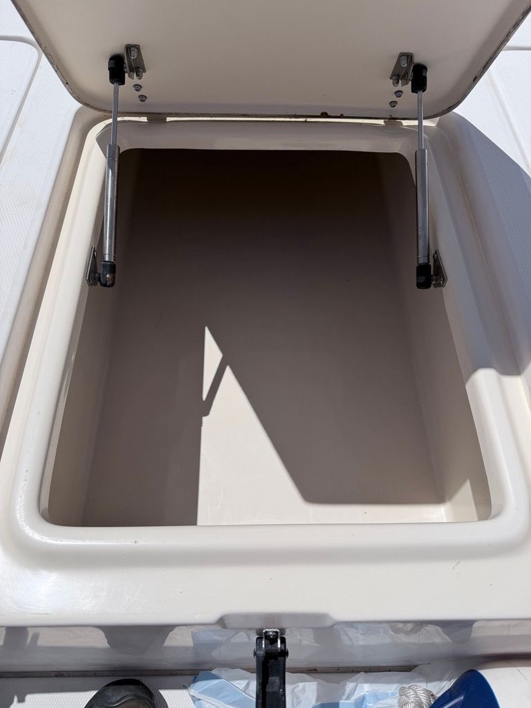 Open storage compartment on a 1999 Grady-White Fisherman 222 boat.