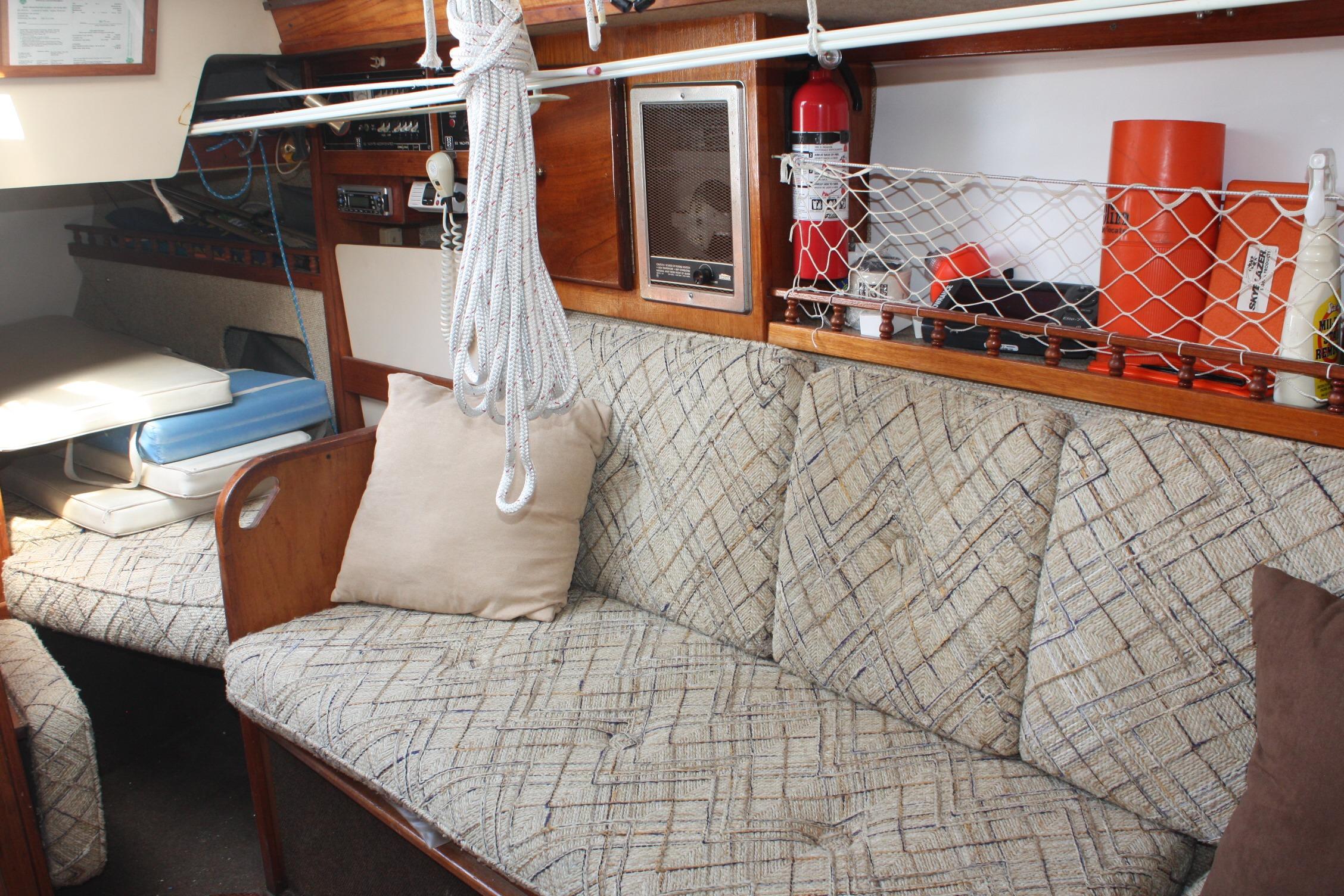Interior of 1981 S2 9.2A sailboat with patterned seating and nautical equipment.