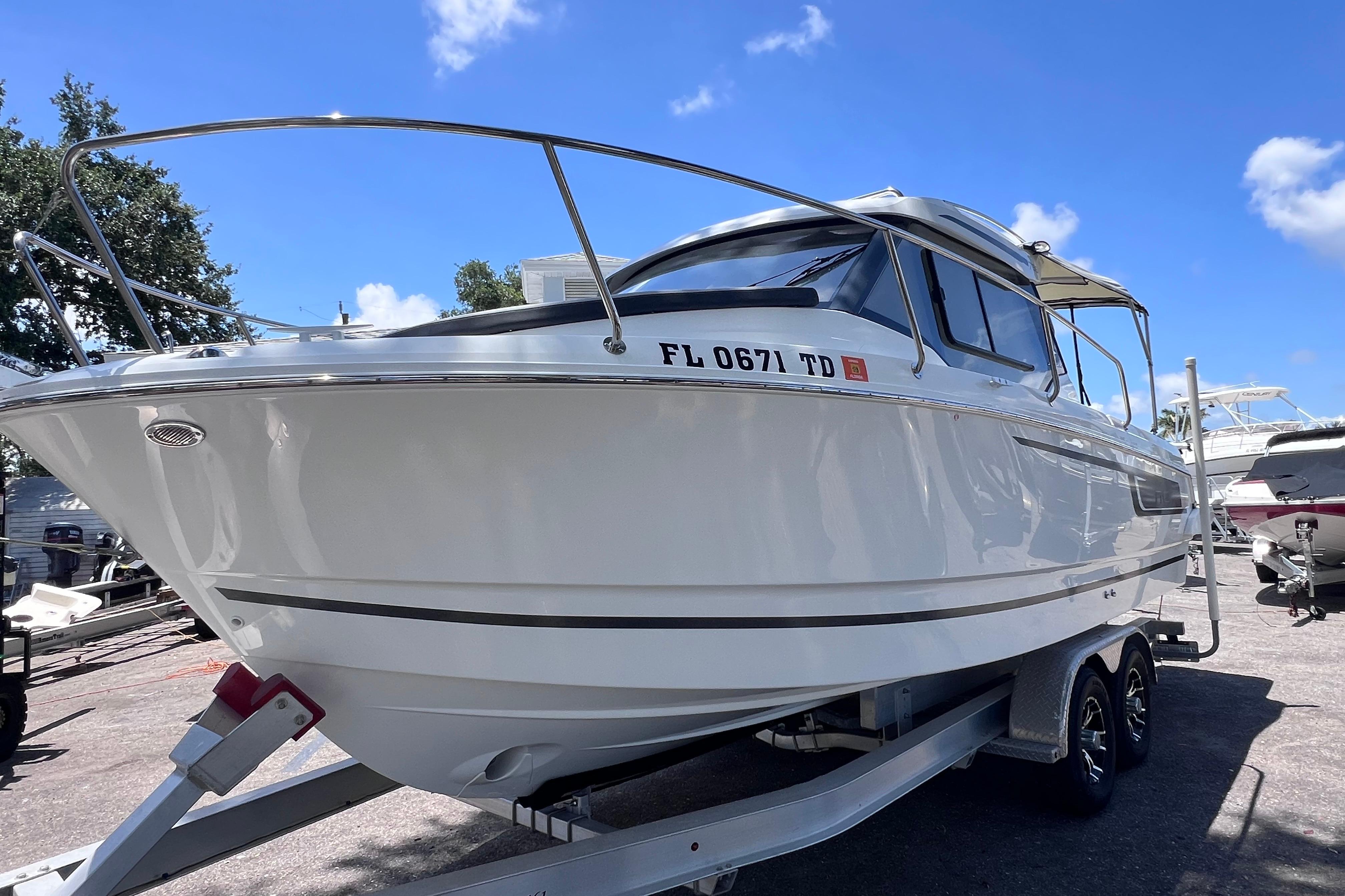 2021 Jeanneau NC Weekender 795 Series 2 boat on trailer under clear blue sky.