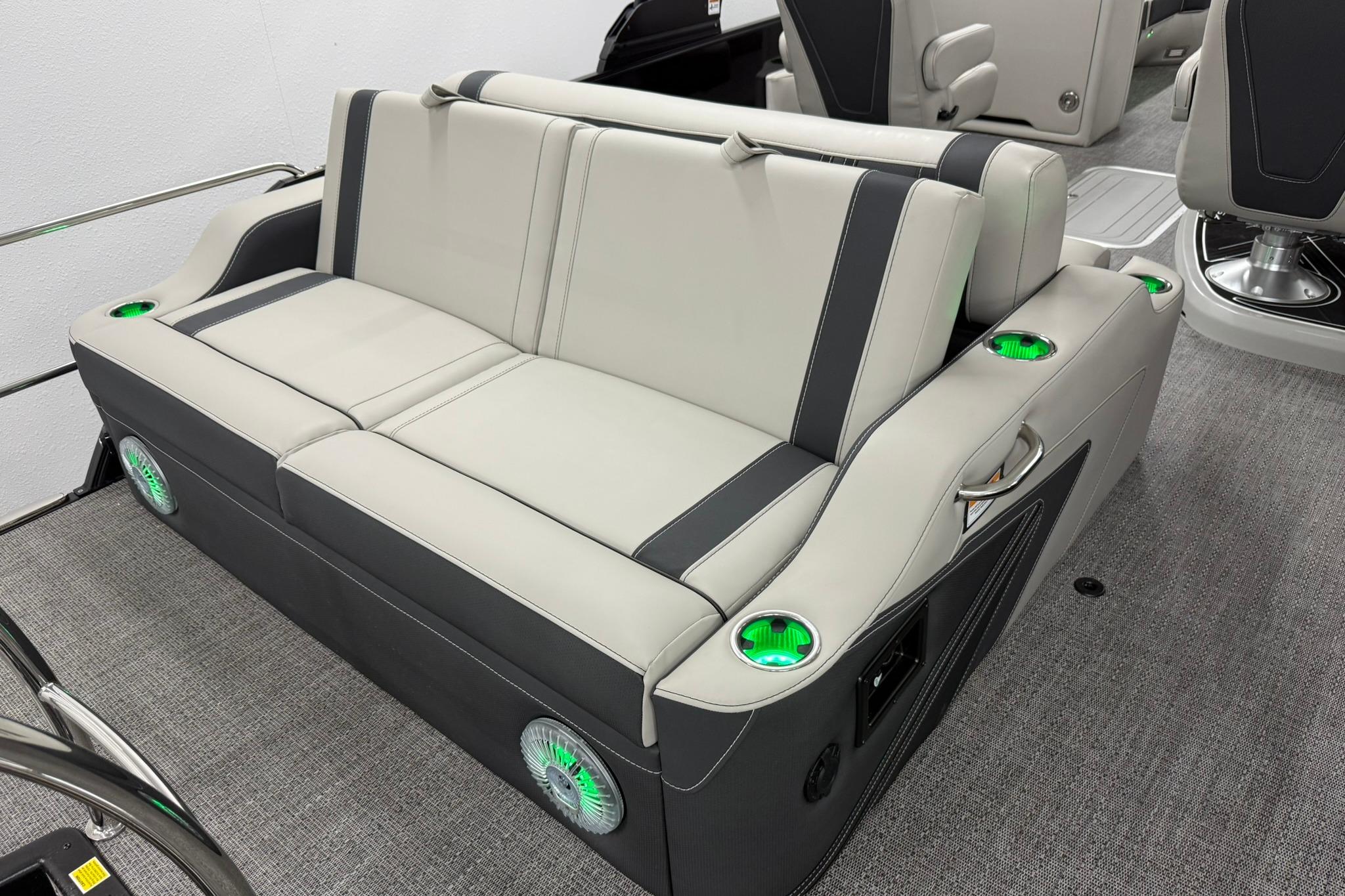 Luxurious seating on 2026 Barletta CORSA 25UC boat with integrated cup holders and speakers.