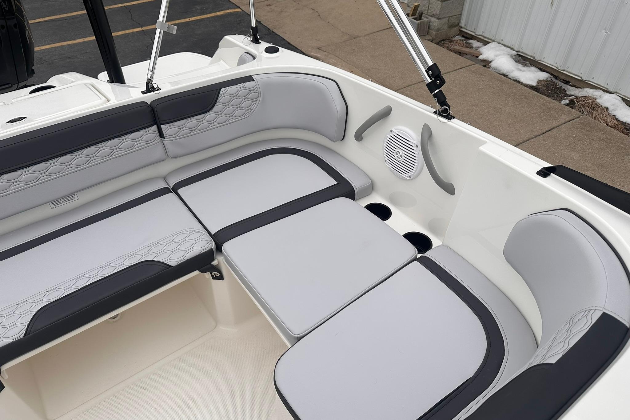 2026 Bayliner M17 boat interior with gray seating and speaker system.
