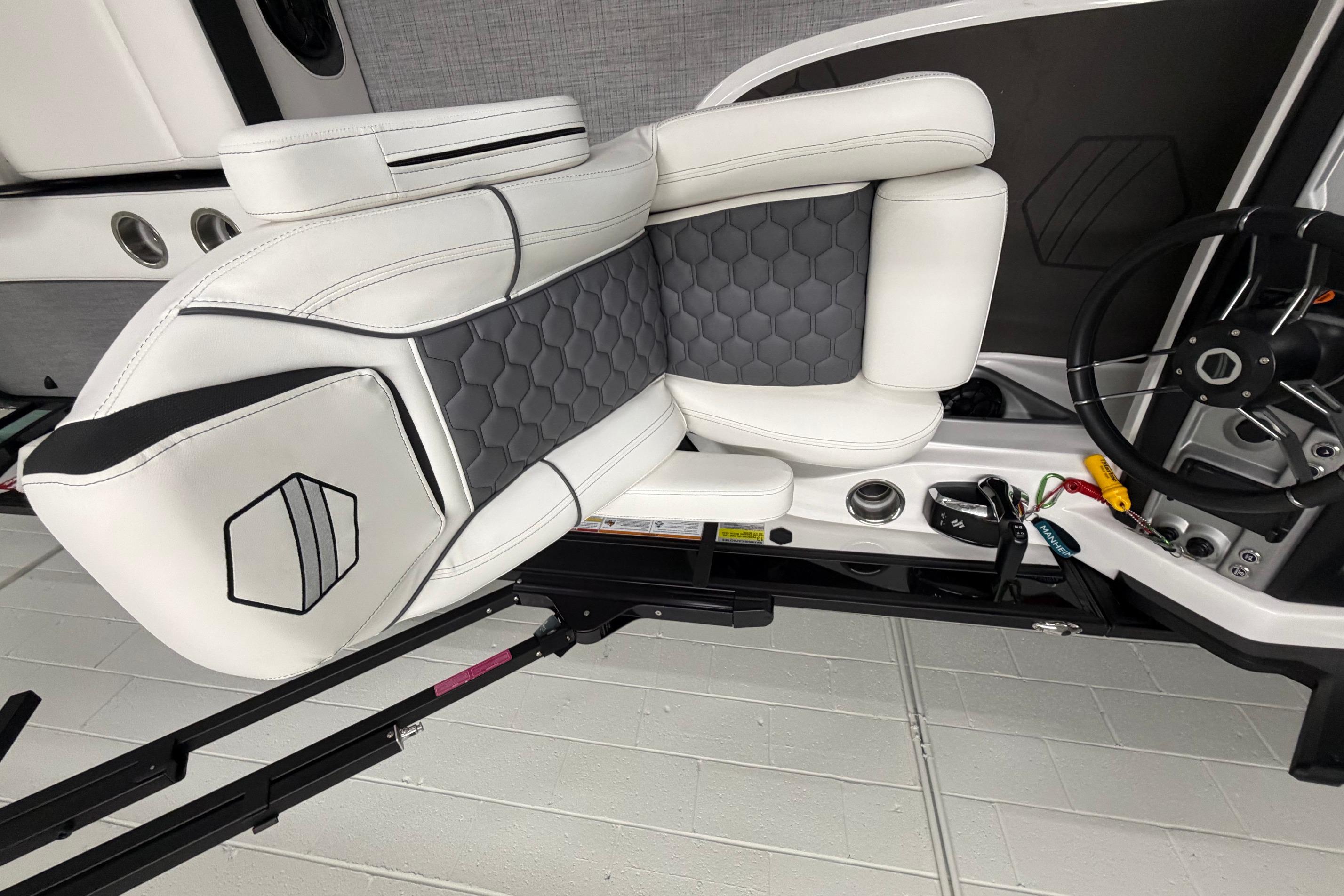 Luxurious interior of 2026 South Bay 525SB2 boat with sleek white and gray seating.