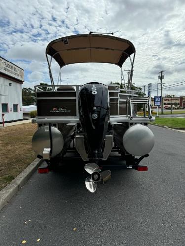 2025 Sun Tracker SportFish 22 XP3 pontoon boat with canopy and outboard motor.