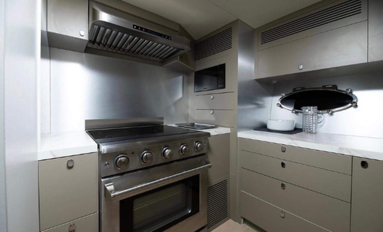 Modern kitchen in 2019 Numarine 78 yacht with stainless steel appliances and sleek cabinetry.