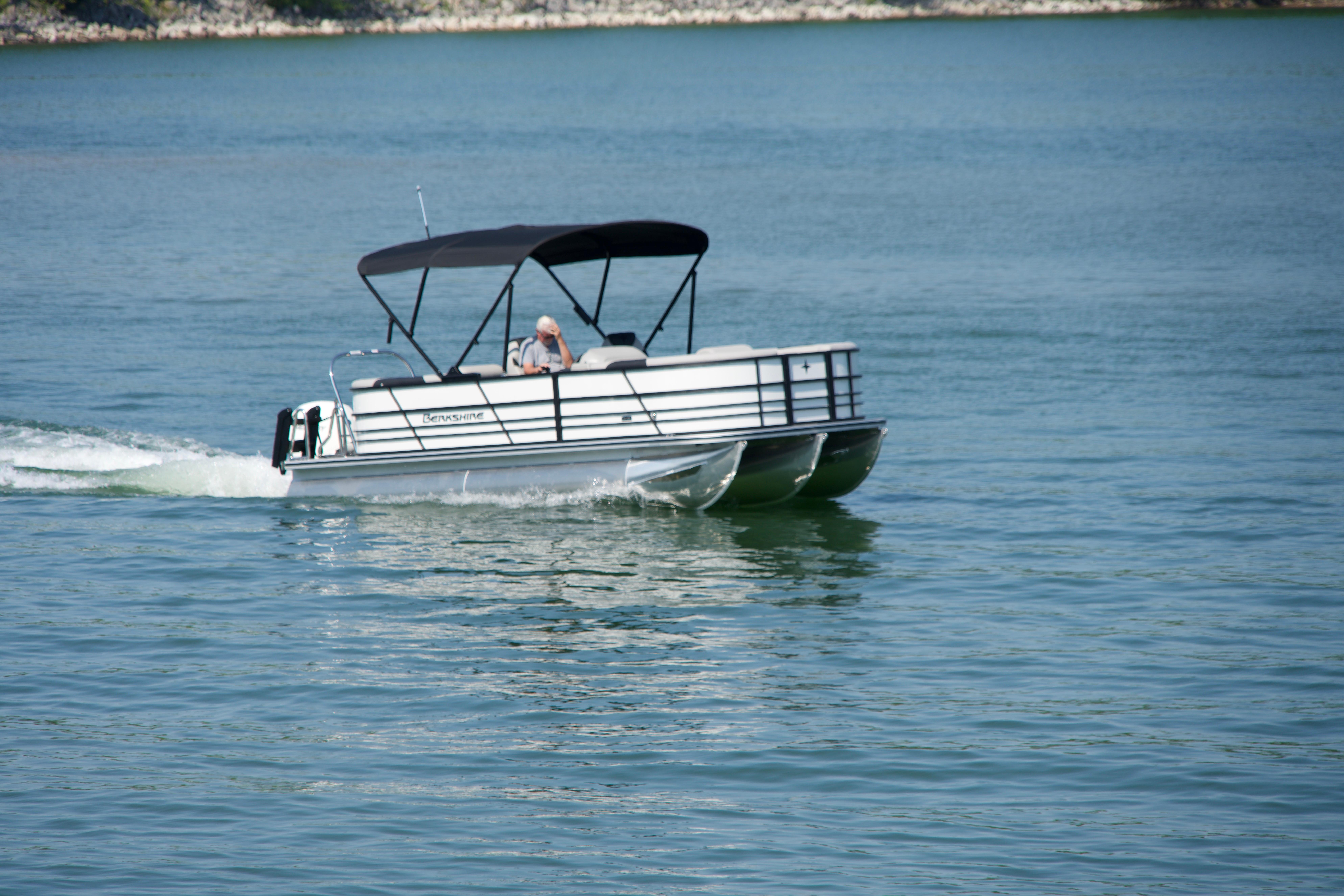 2026 Berkshire 22 RFX LE pontoon boat cruising on a calm lake.