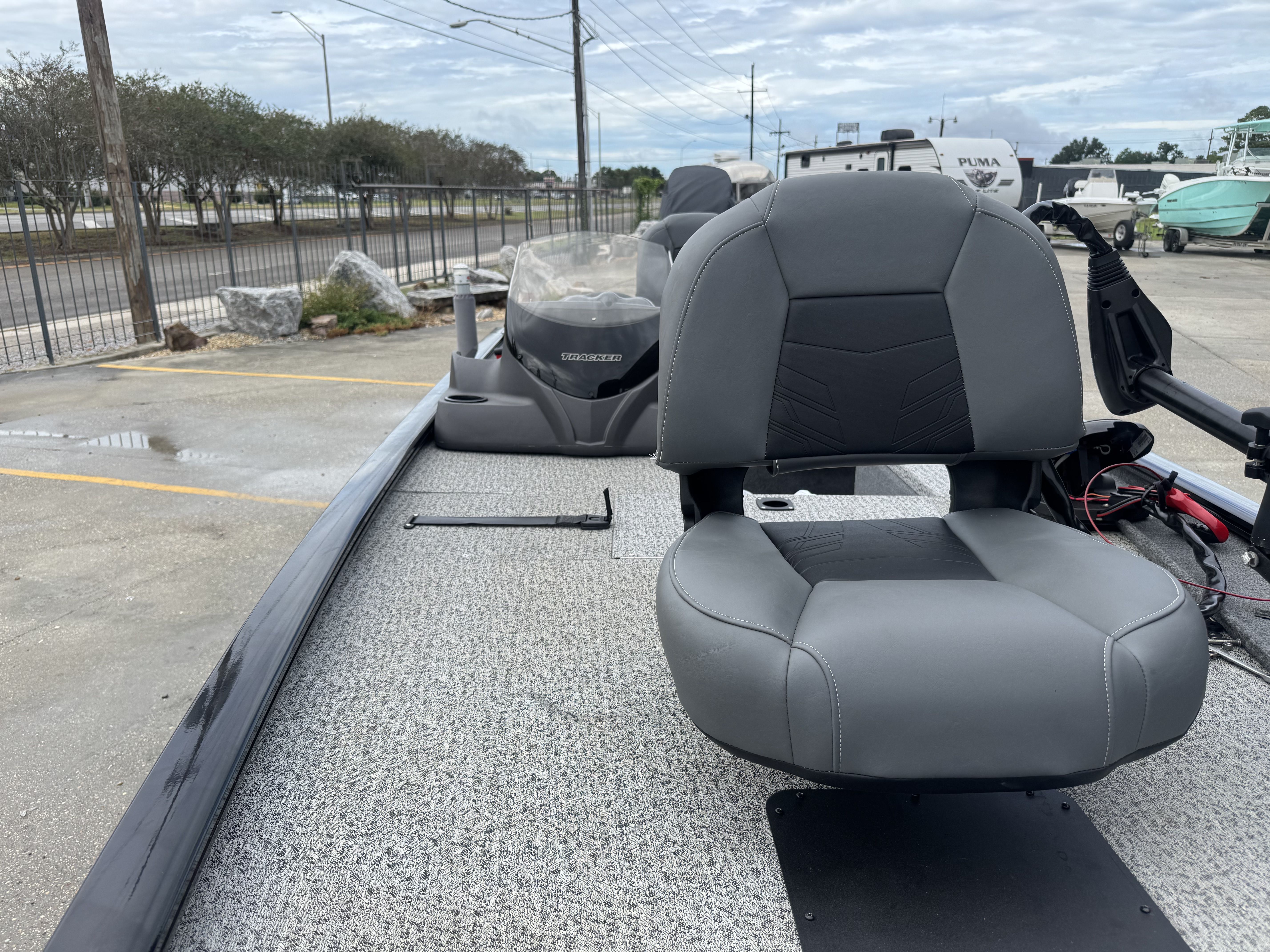2024 Tracker Pro 170 boat with gray seating, parked outdoors on a cloudy day.