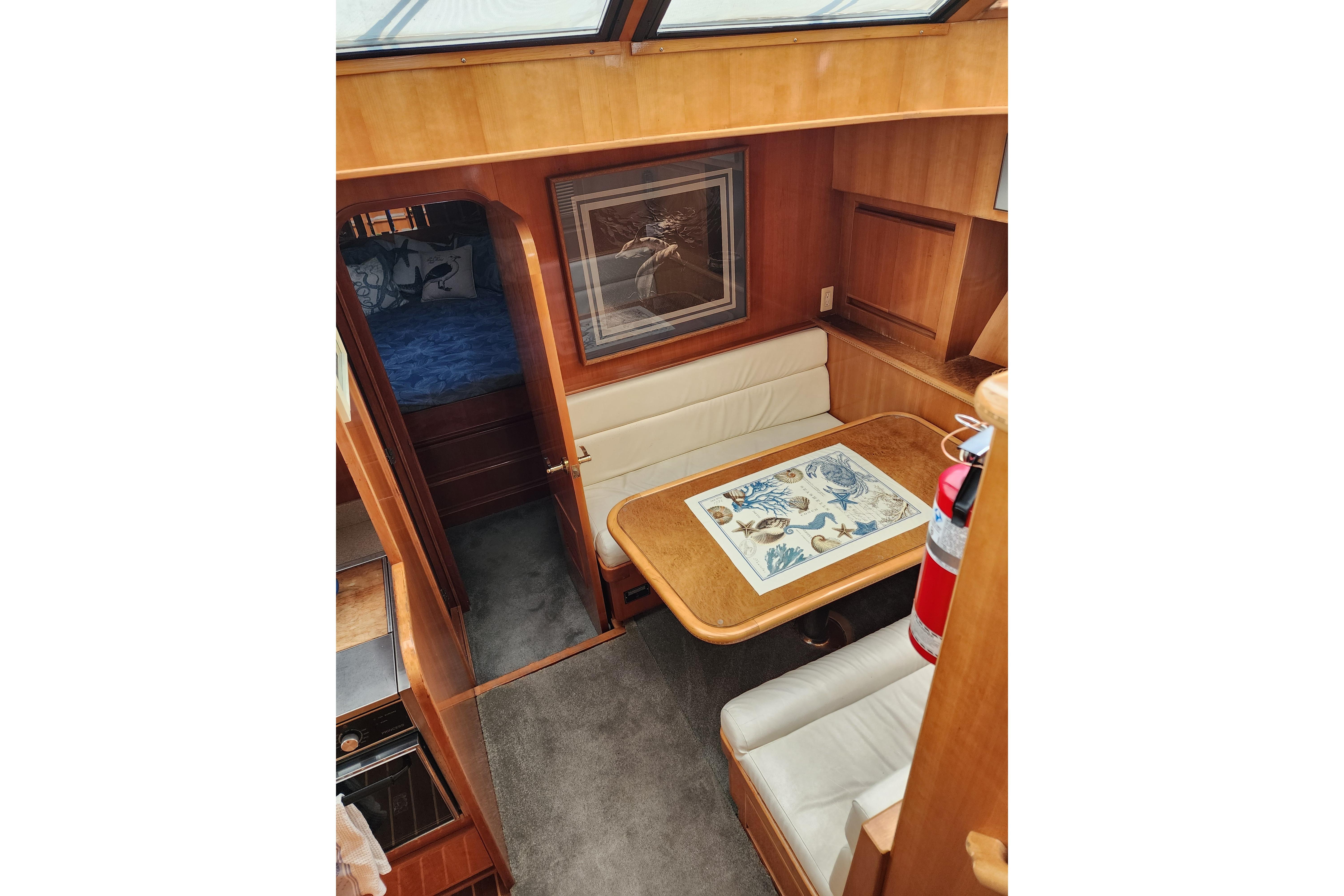 Interior of 2000 Novatec Cockpit Motor Yacht with dining area and cozy seating.