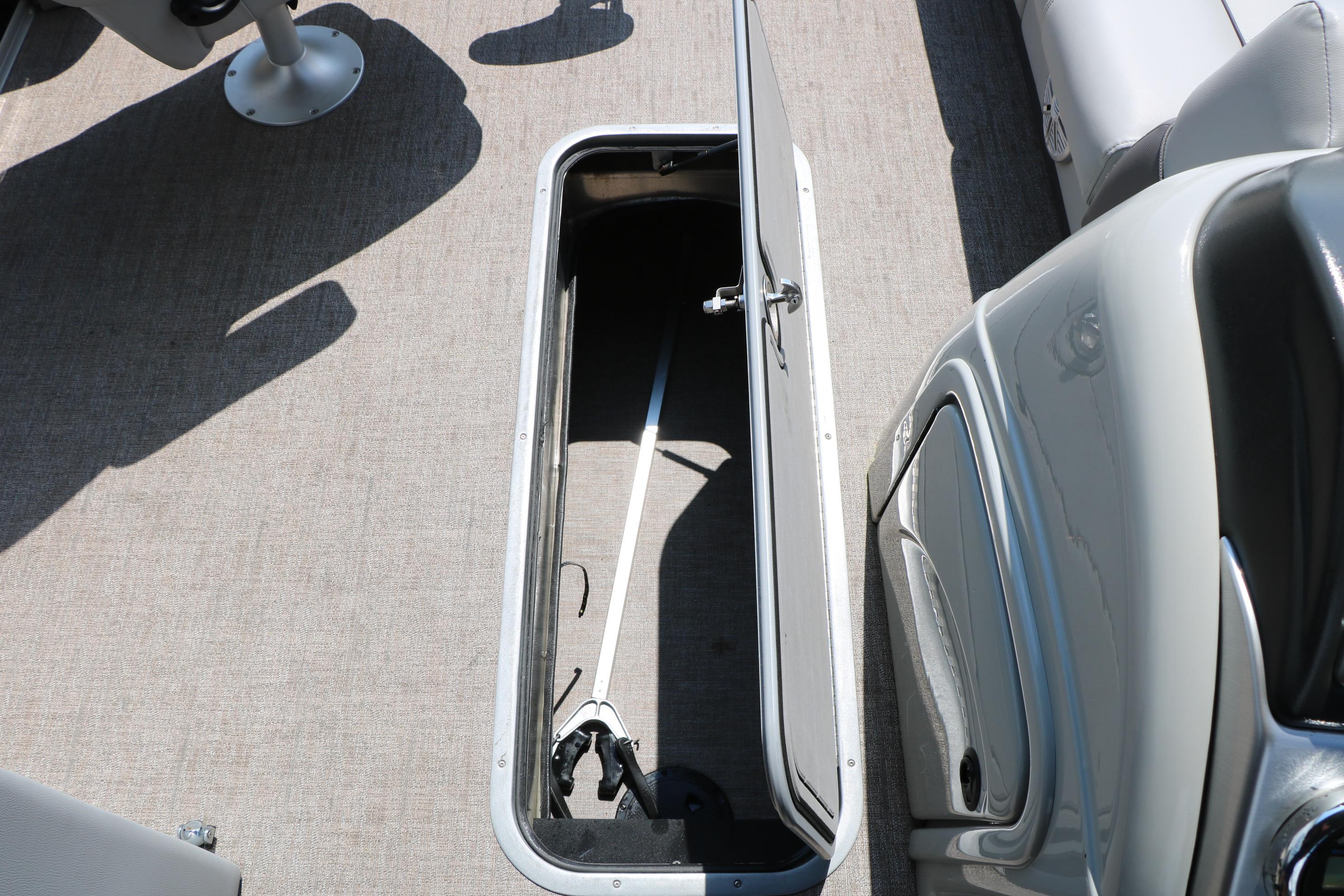 Open storage compartment on 2021 Ranger 223FC boat with gray interior.