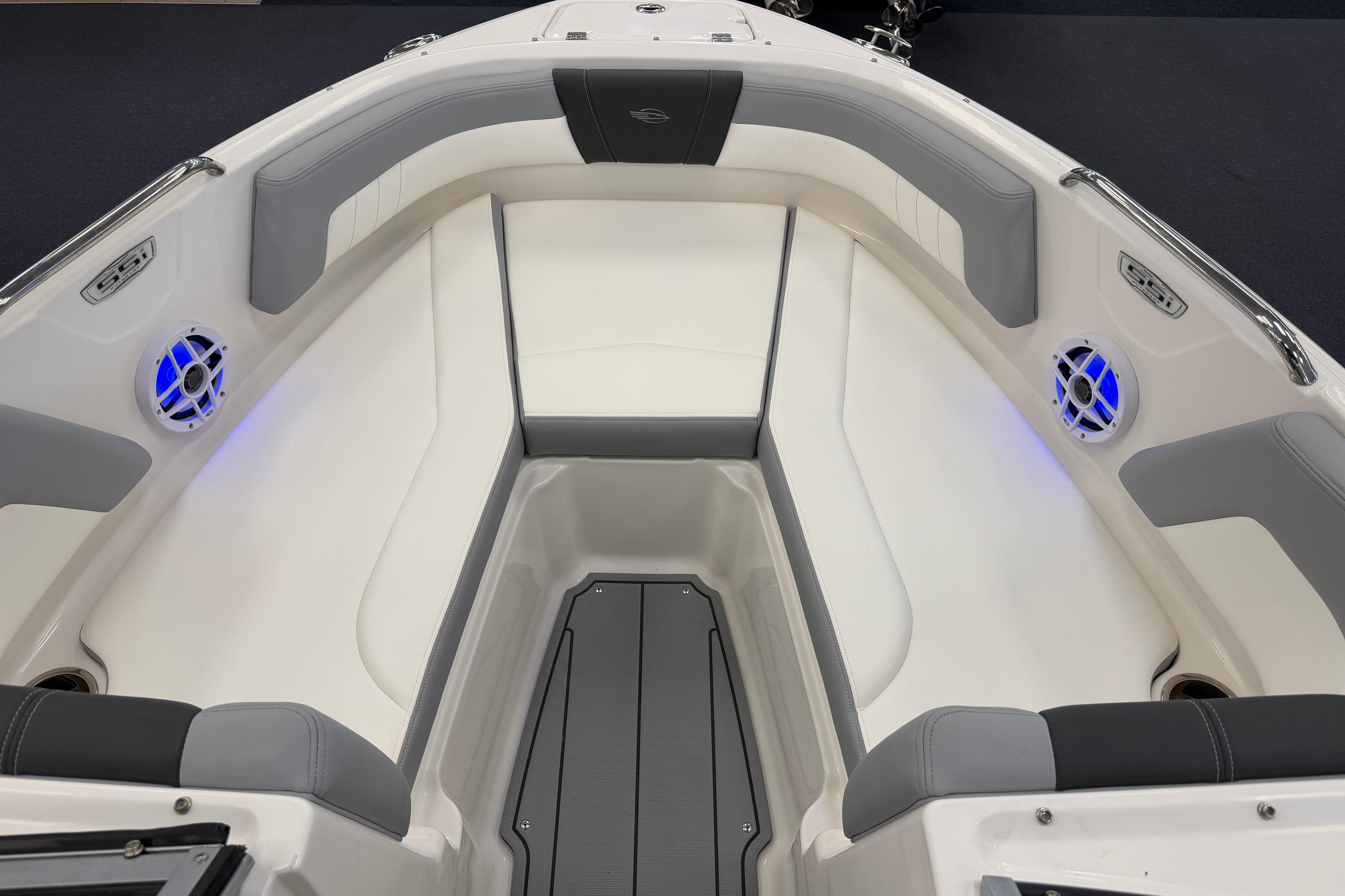 2025 Chaparral 21 SSi OB boat interior with cushioned seating and blue LED lights.