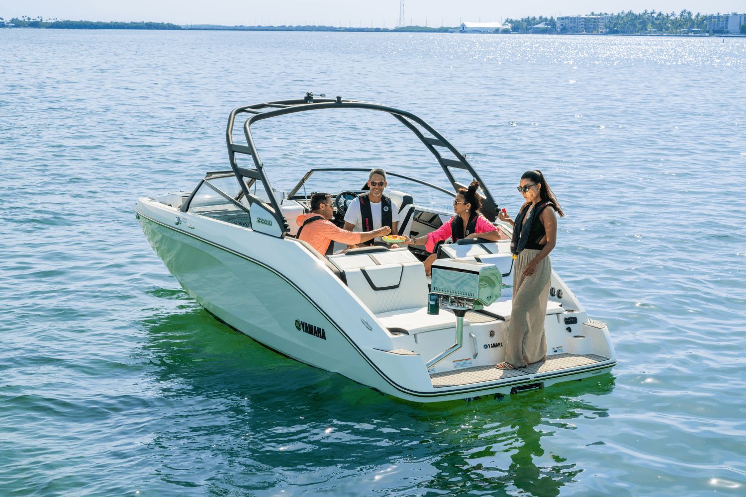 2026 Yamaha 222SD with four people on board, floating on calm water.