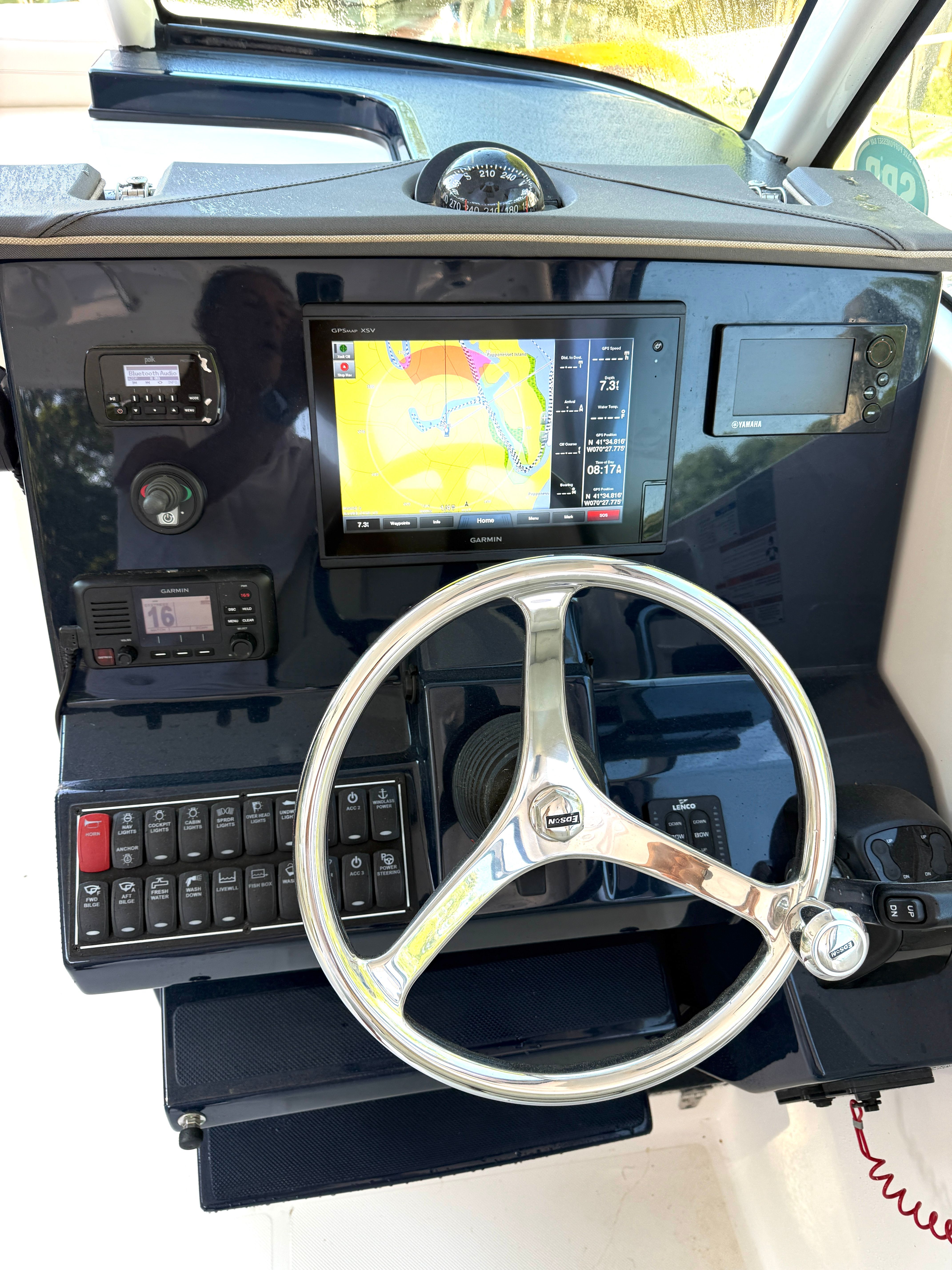 The image shows the helm of a 2017 Pursuit DC 295 Dual Console boat with a modern navigation system.