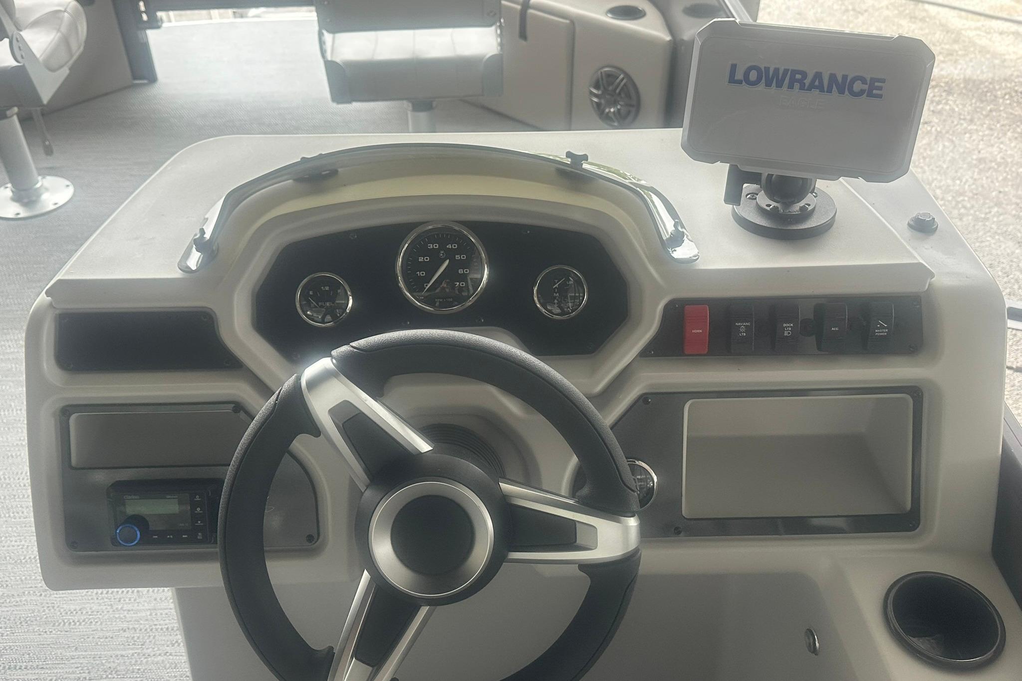 Steering console of 2026 Sweetwater 2286FX boat with Lowrance navigation system.