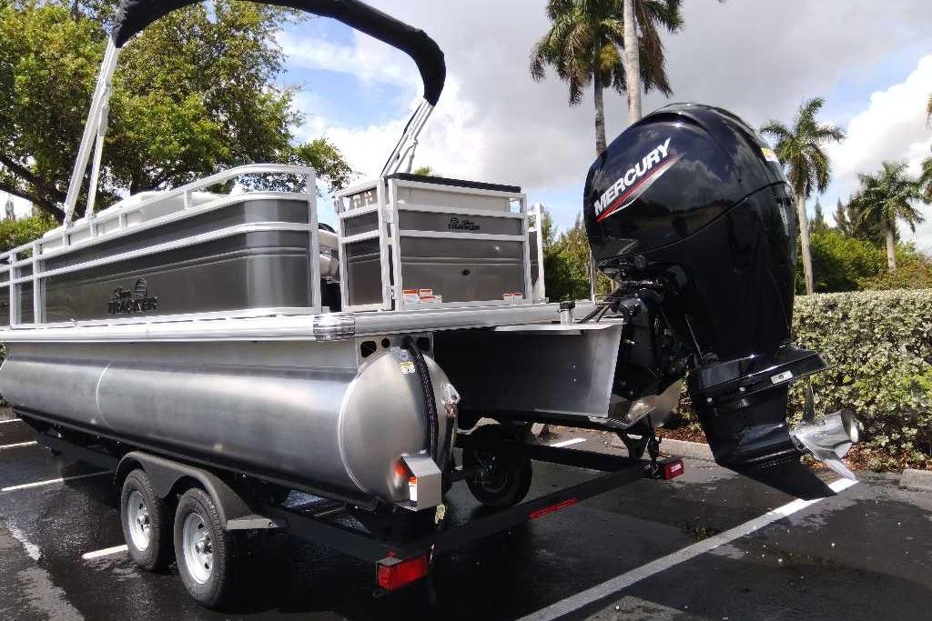 2026 Sun Tracker Fishin' Barge 22 DLX pontoon boat with Mercury outboard motor.