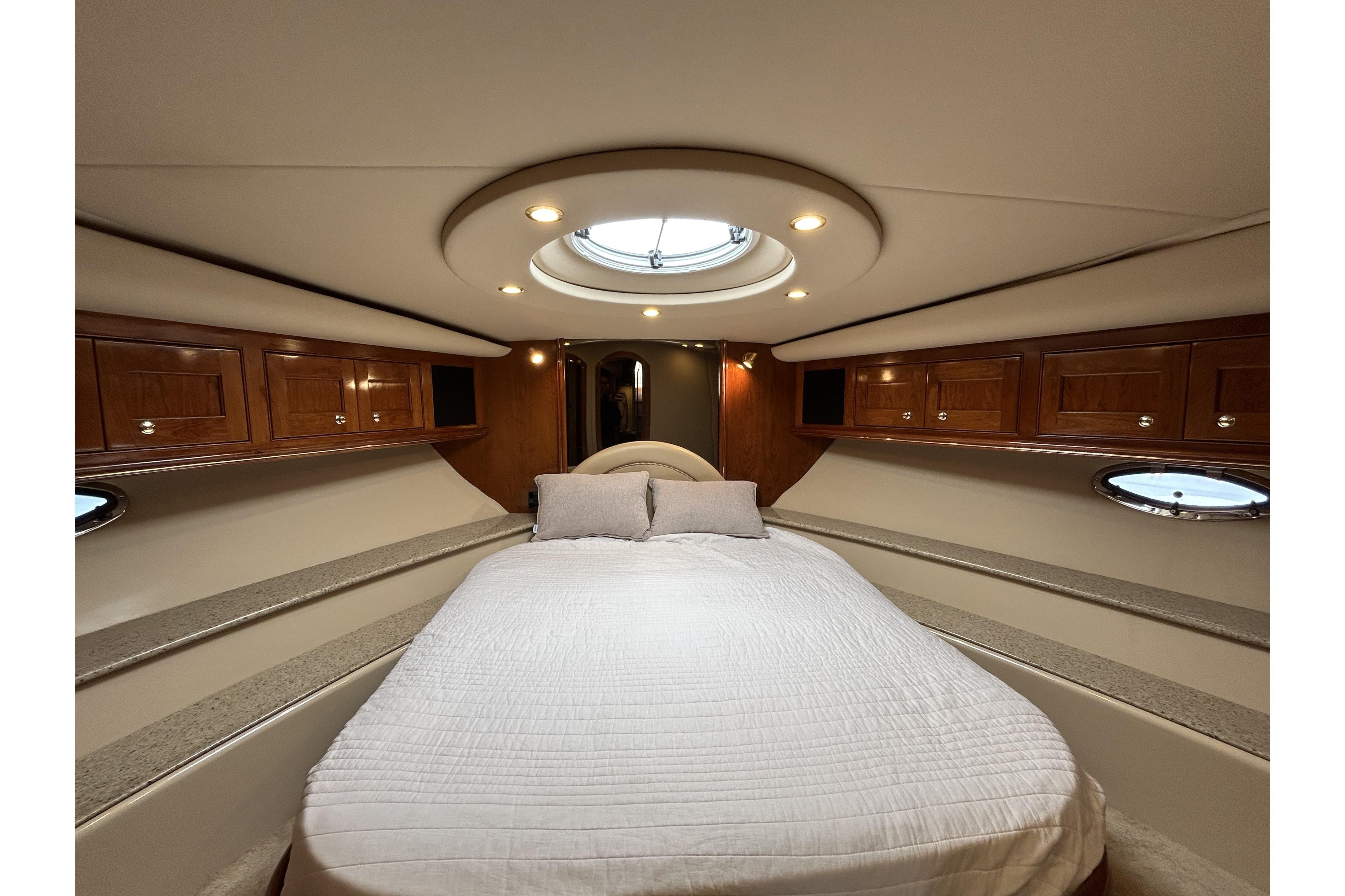 Luxurious cabin interior of 2003 Cruisers Yachts 540 Express with elegant wood finish.