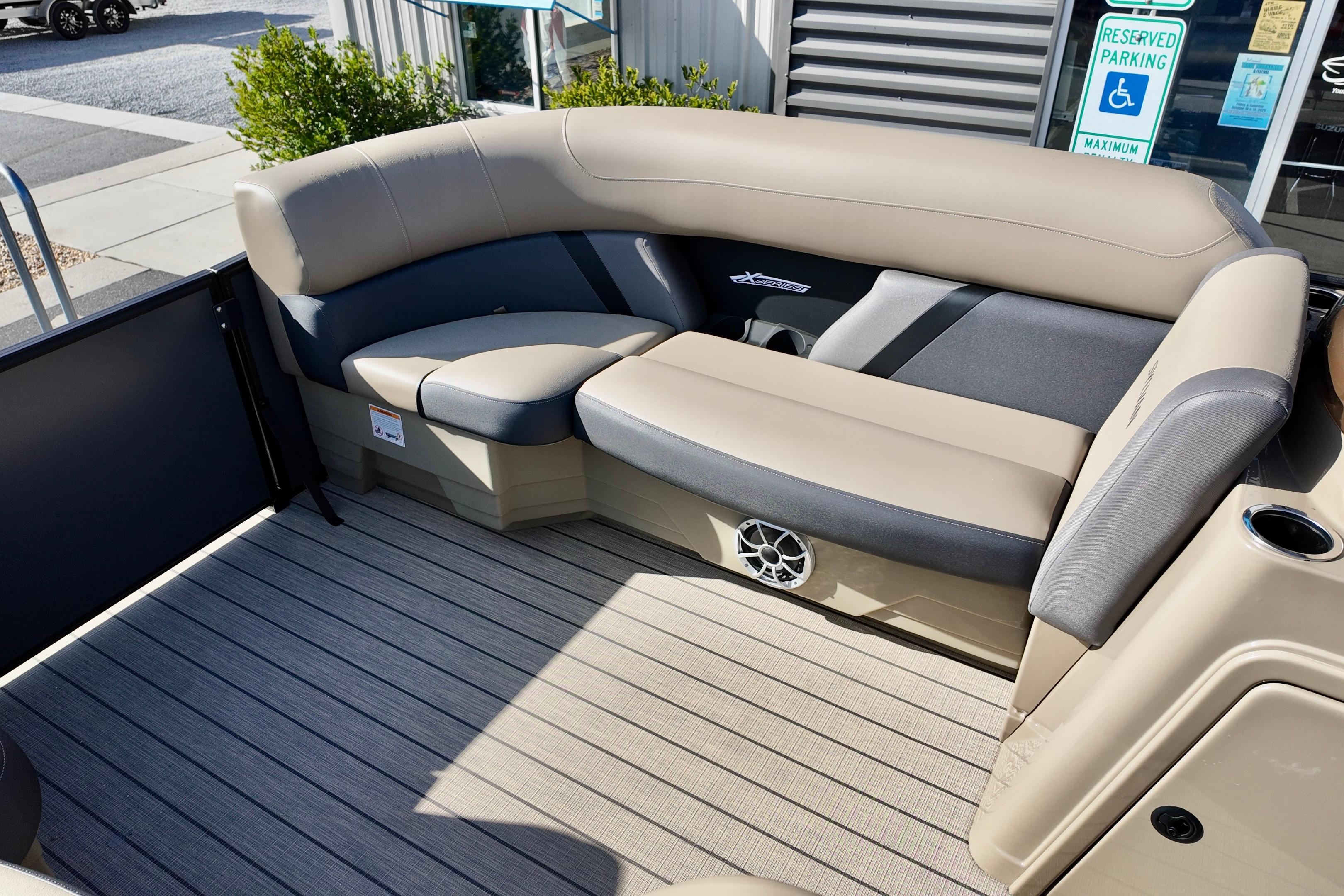 2026 Sylvan Mirage X3 CLZ boat interior with beige seating and speaker system.