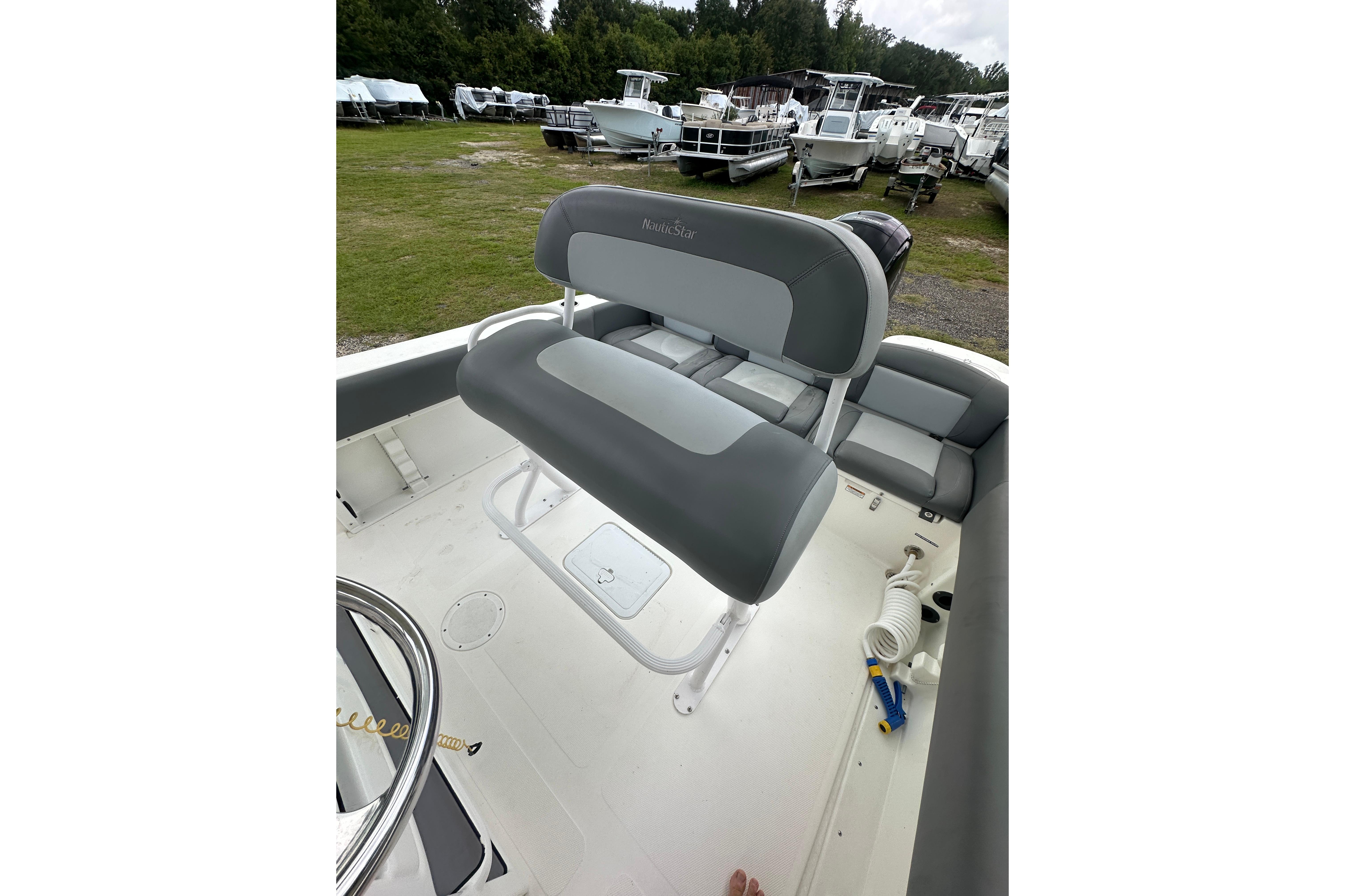 2023 NauticStar 2102 Legacy boat interior with gray seating and steering wheel.