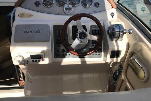2006 Chris Craft Corsair Heritage dashboard with Garmin navigation and classic steering wheel.