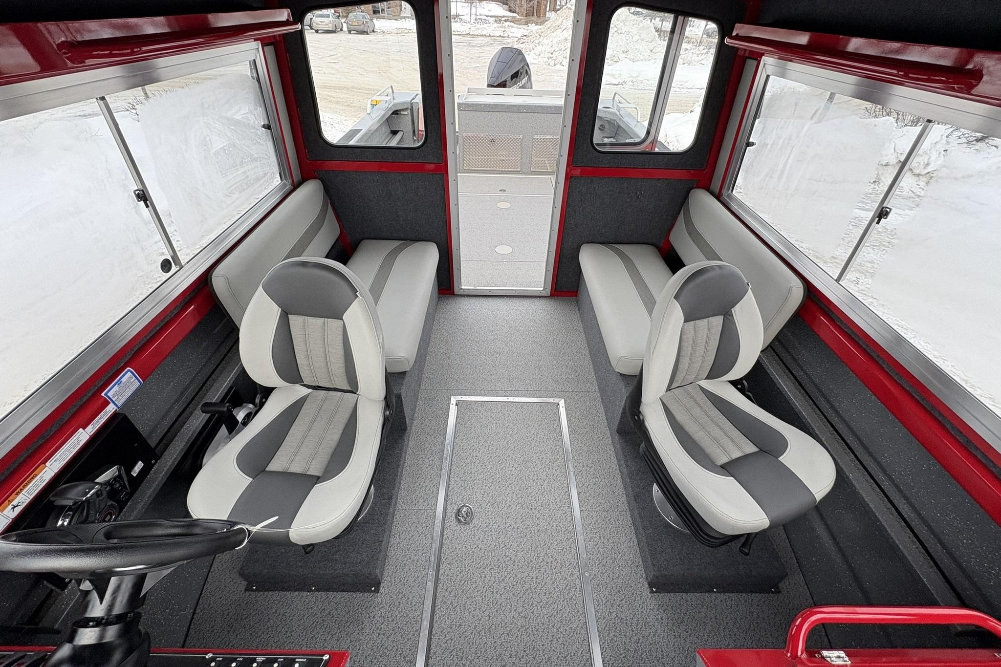2024 Spartan 240 Maximus Pro interior with gray seating and red accents.