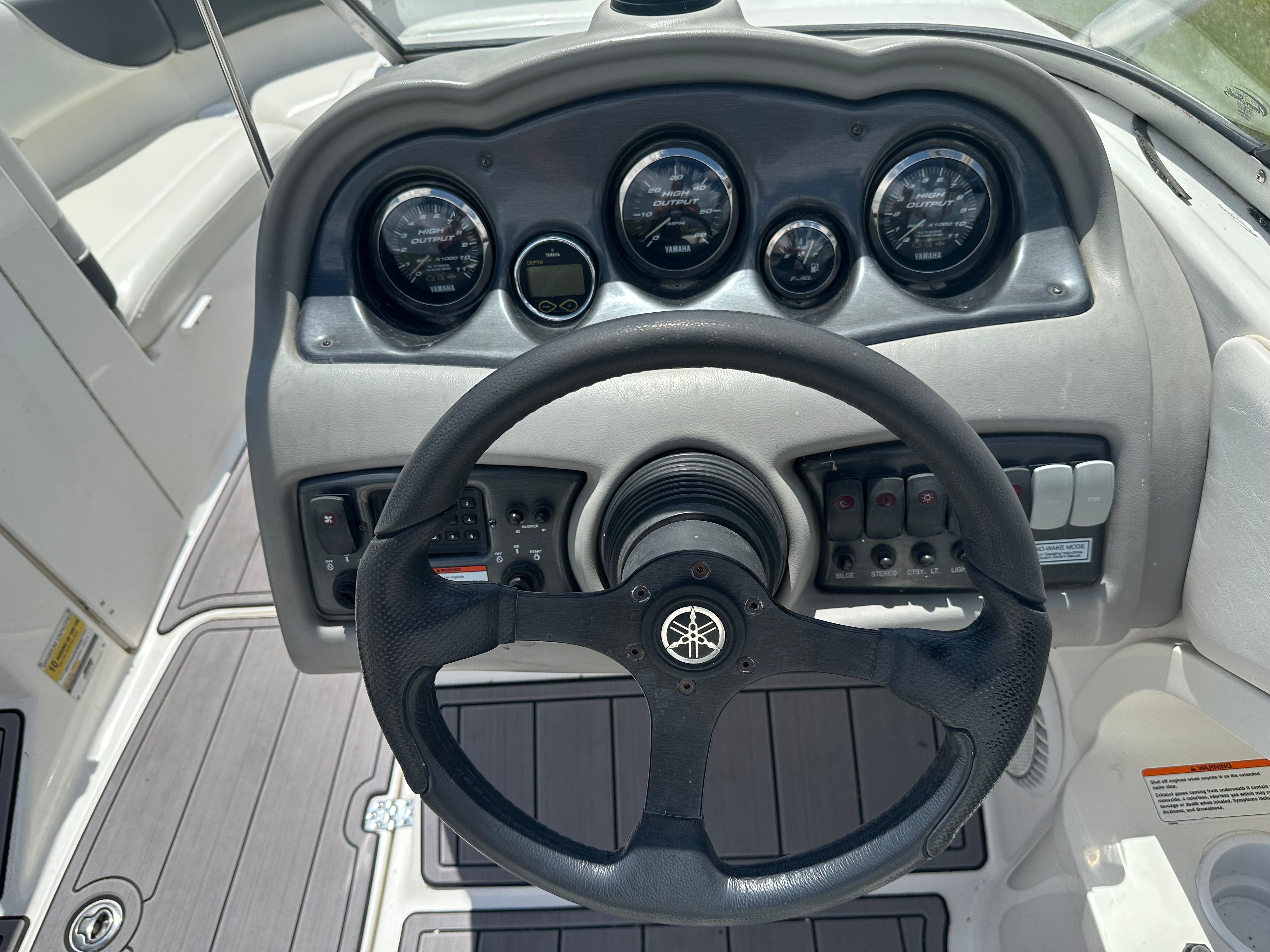 Yamaha AR230 HO 2005 boat dashboard with steering wheel and gauges.