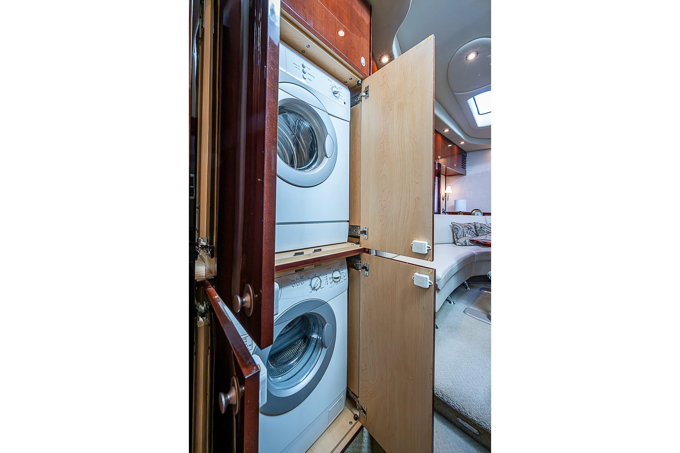 Laundry area inside 2008 Sea Ray 60 Sundancer yacht, featuring stacked washer and dryer.