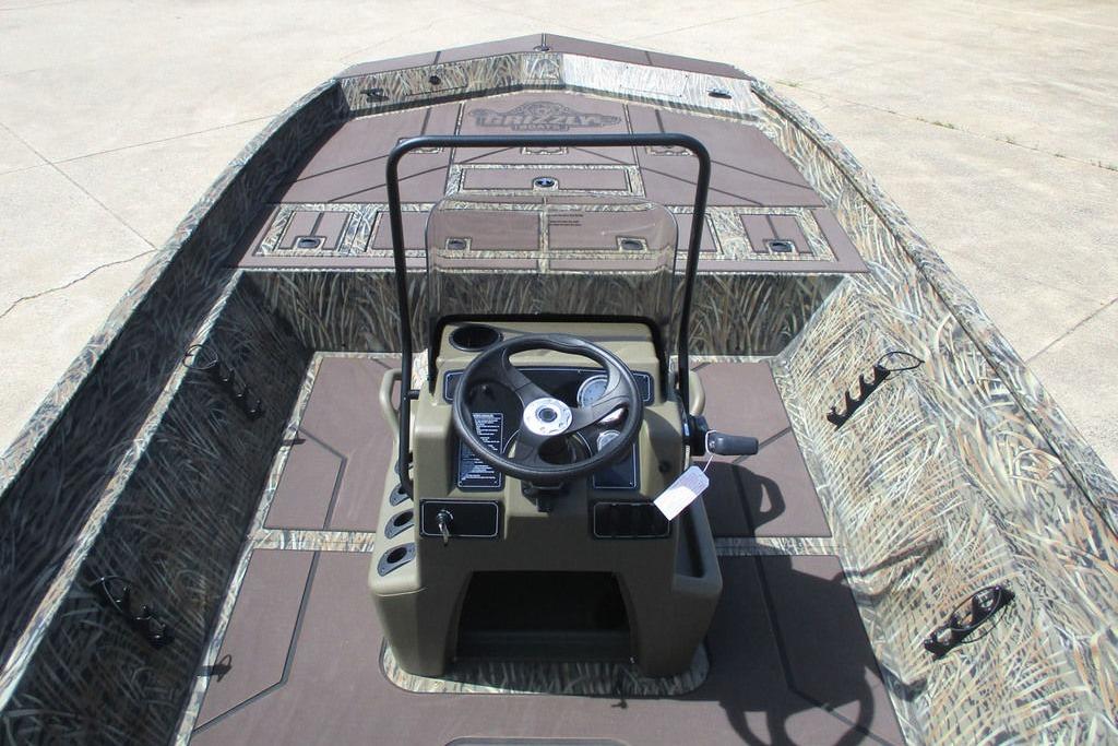 2026 Tracker Grizzly 2072 CC boat interior with camouflage design and steering console.