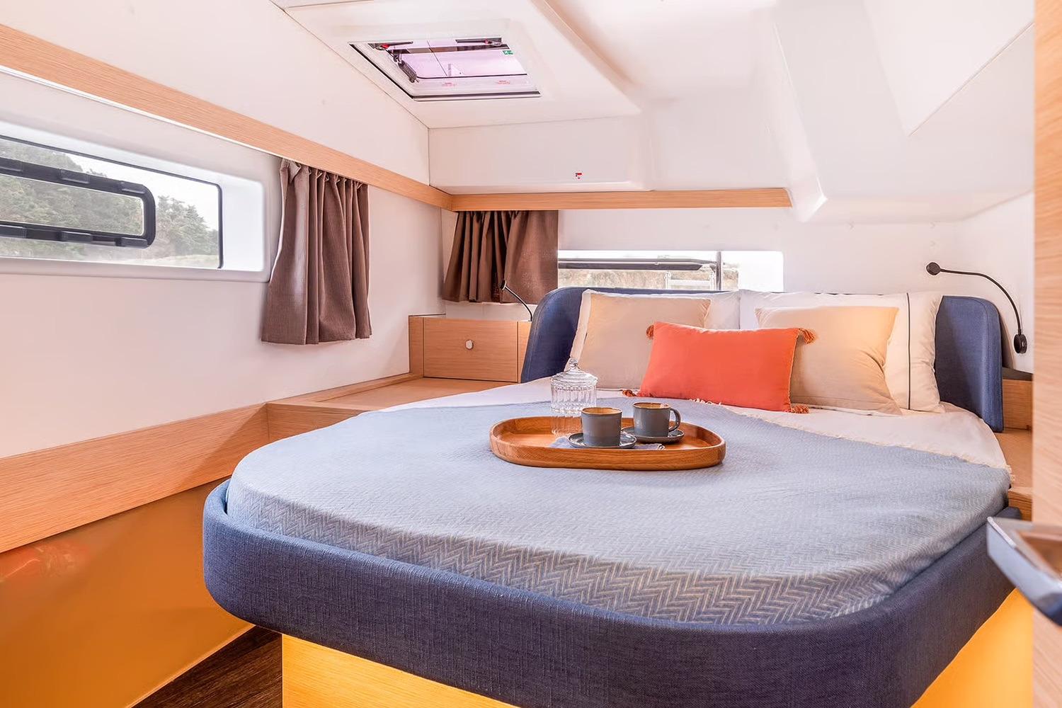 Manufacturer Provided Image: Luxurious bedroom interior of 2026 Fountaine Pajot FP41 Catamaran with cozy bedding and natural light.