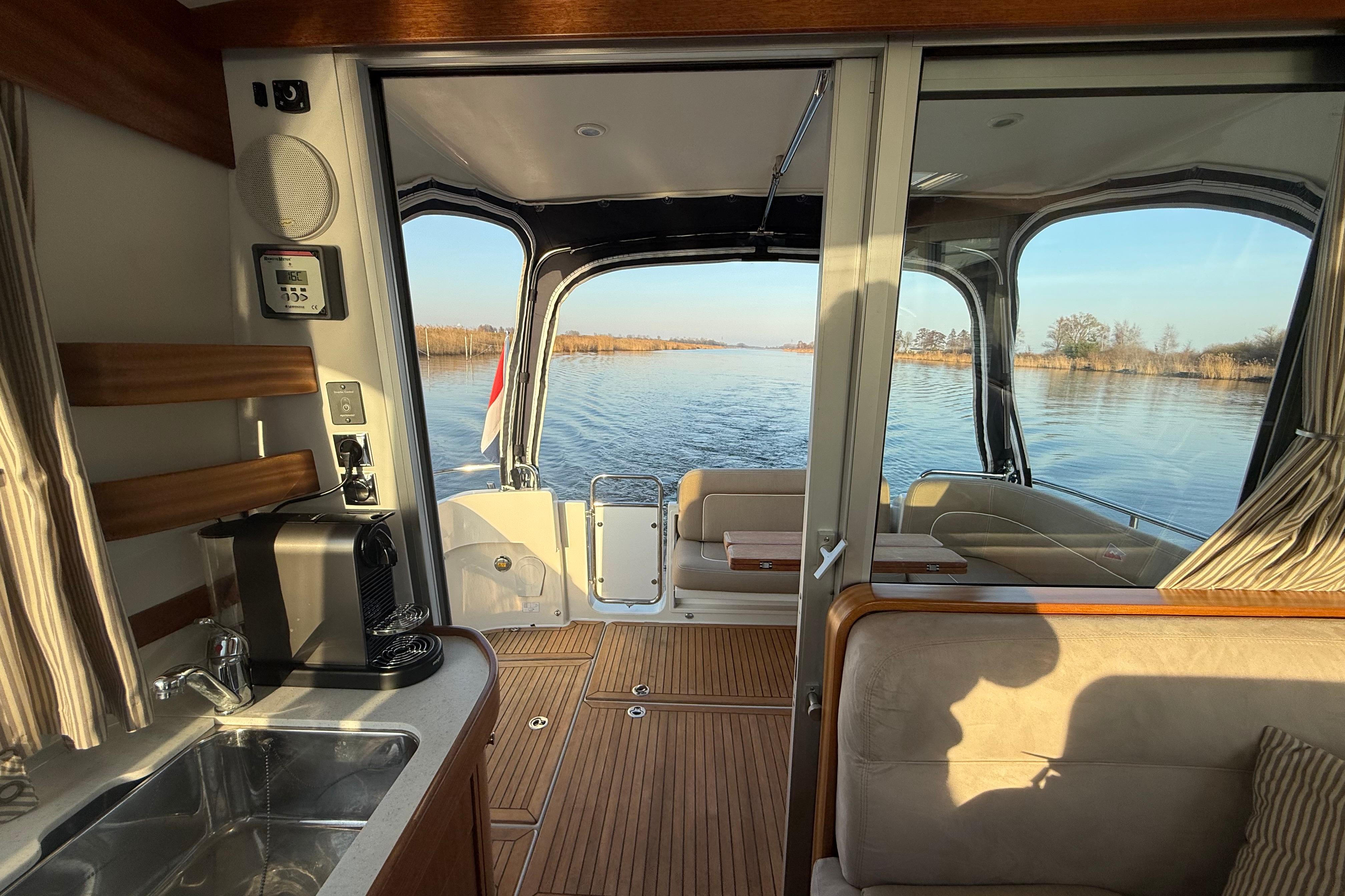 Interior view of 2011 Nimbus 335 Coupe boat with scenic waterway.