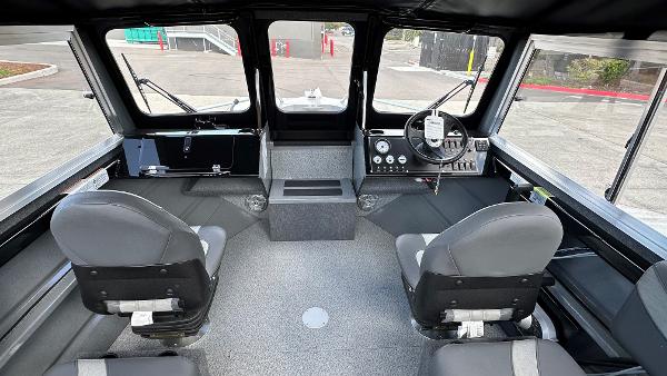 2024 Spartan 200 Astoria boat interior with dual seats and modern dashboard.