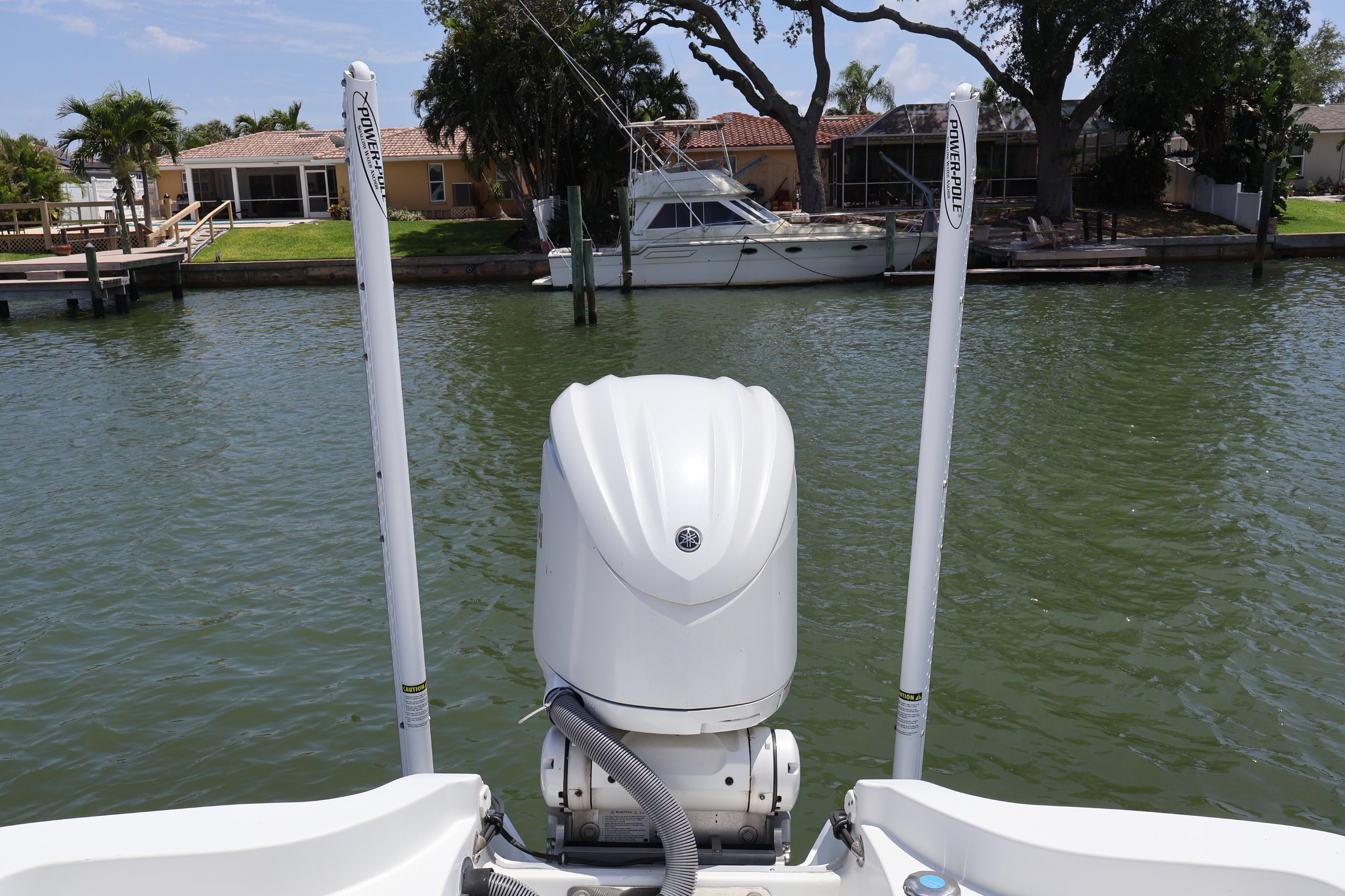 2022 Sea Hunt BX 25 FS boat with Yamaha outboard motor on a calm waterfront.