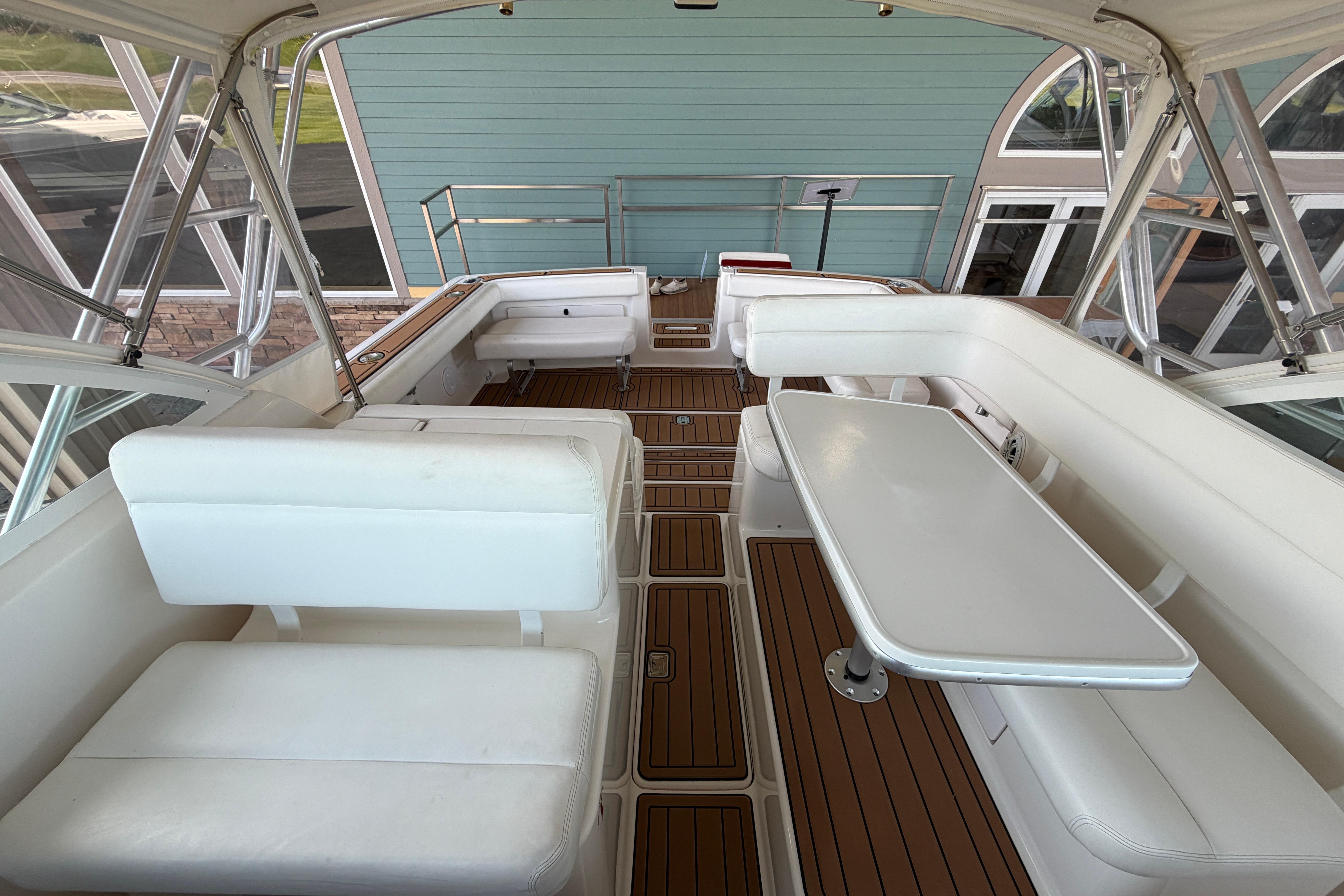 1999 Tiara Yachts 2900 Coronet interior with white seating and wooden flooring.