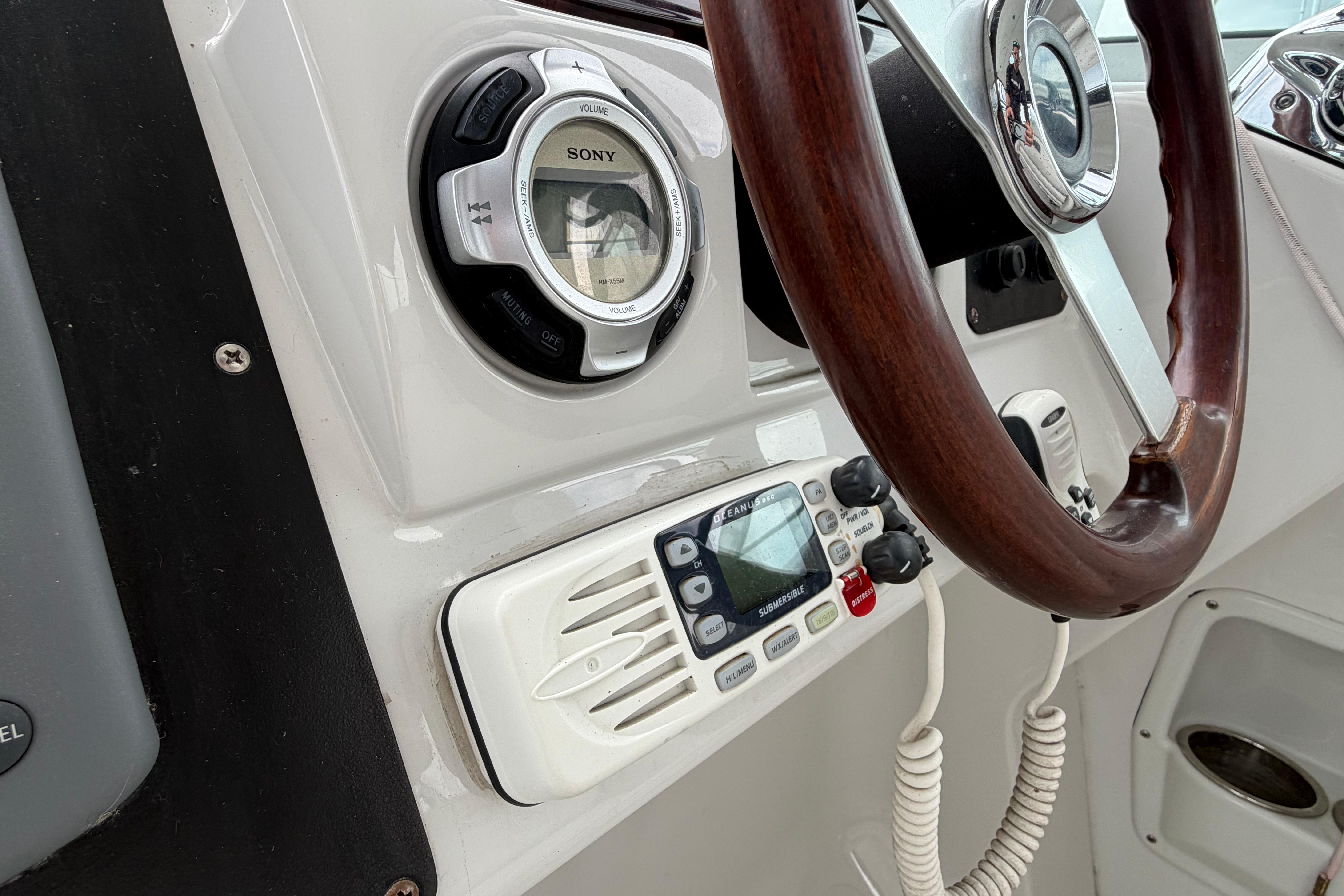 Steering wheel and controls of 2008 Crownline 340 CR boat cockpit.