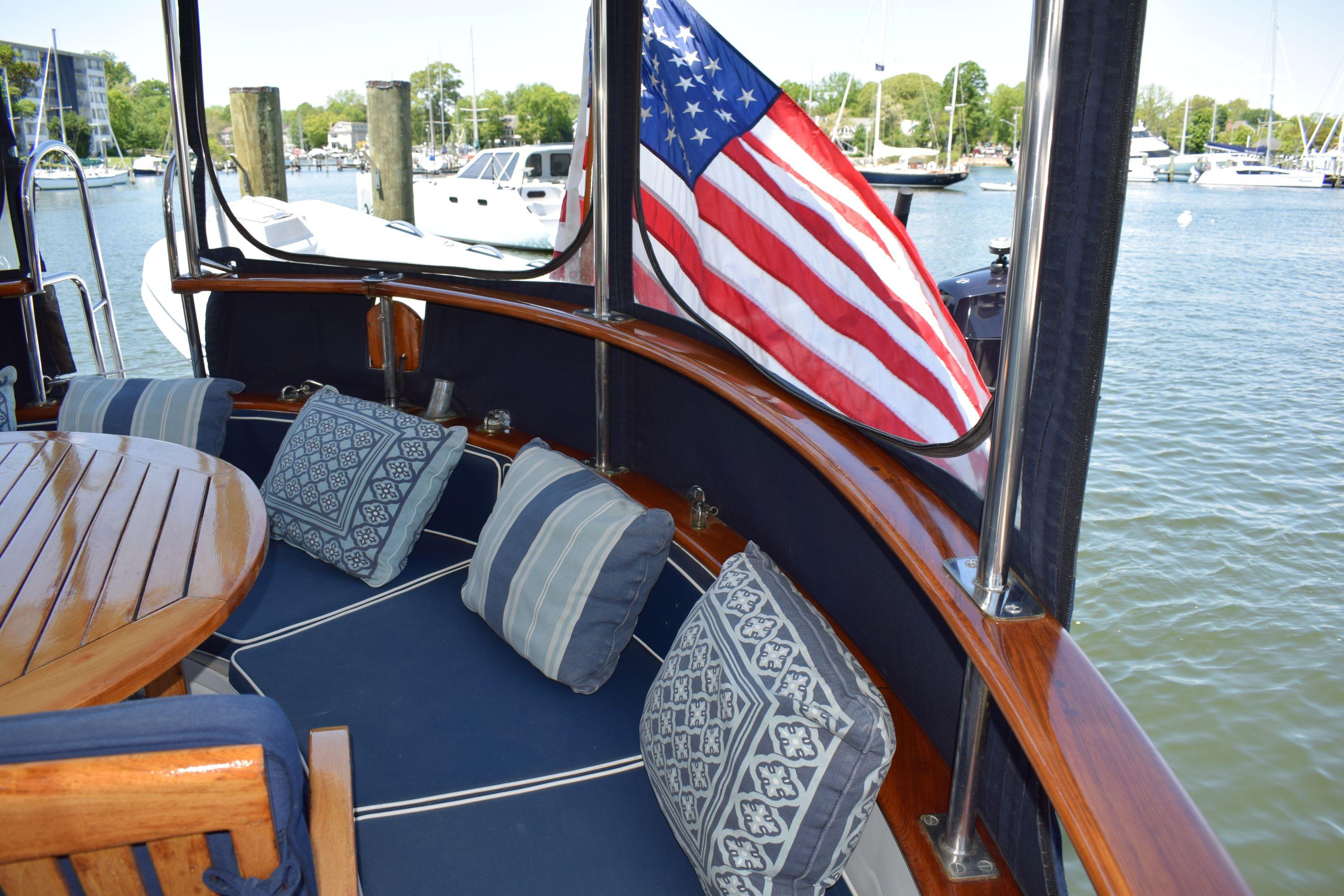 Cozy seating area on 1980 Cheoy Lee 52 Motorsailer with American flag.