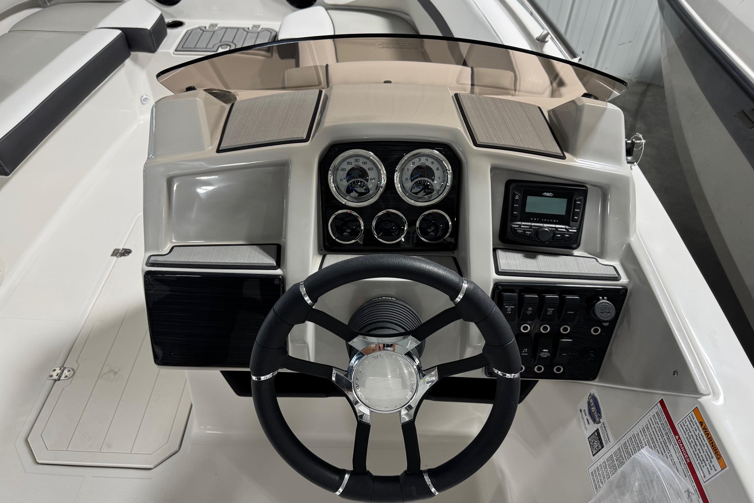 2026 Starcraft SVX 191 OB boat dashboard with steering wheel and control panel.