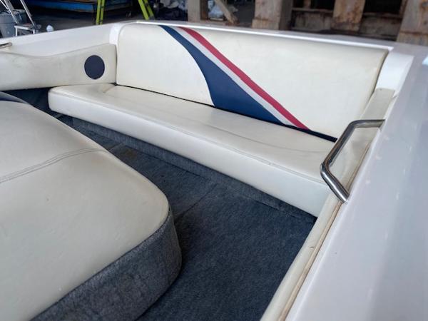 1998 Malibu Response boat interior with white seating and blue-red accents.