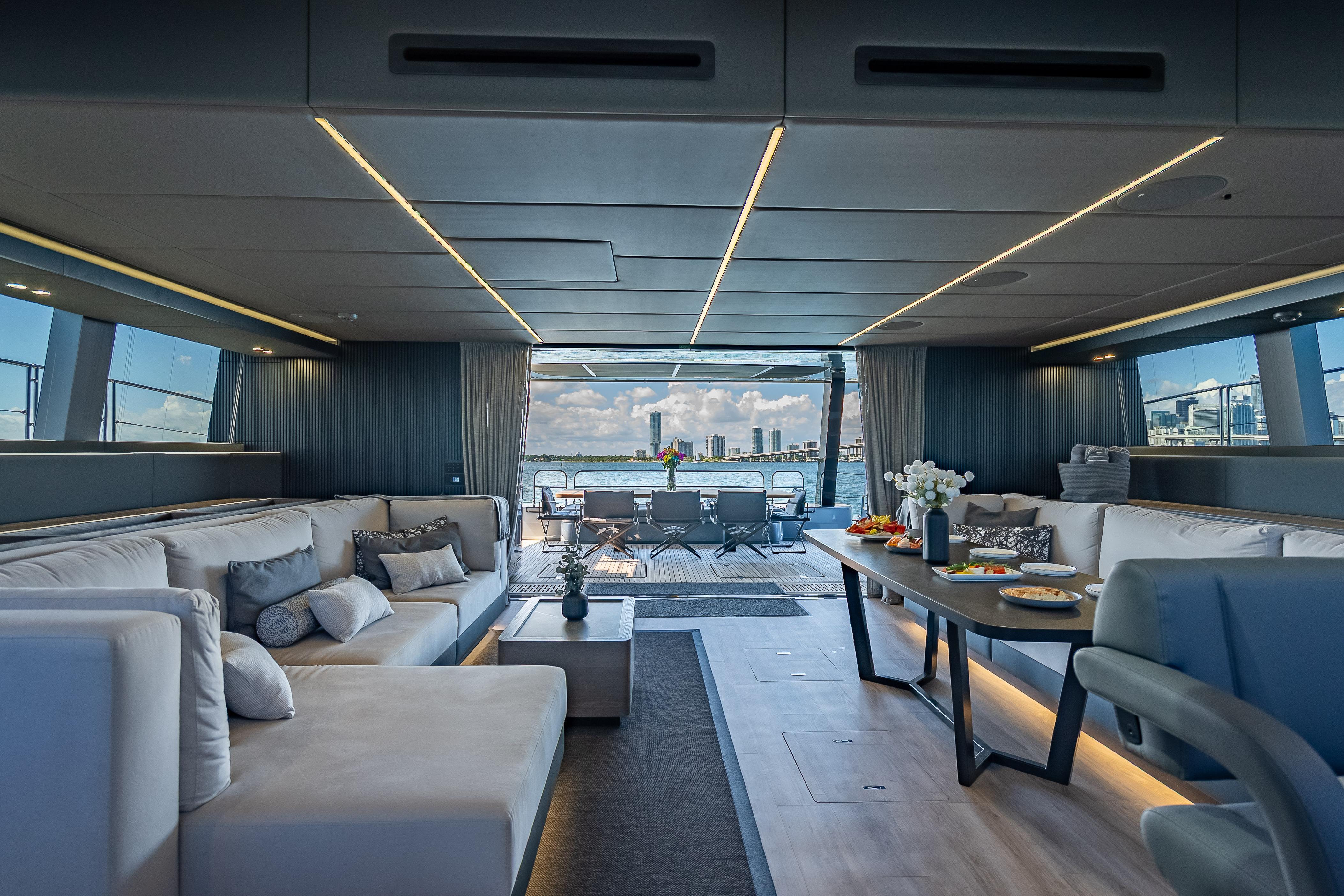 Luxurious interior of 2026 Sunreef 60 Power yacht with elegant seating and dining area.