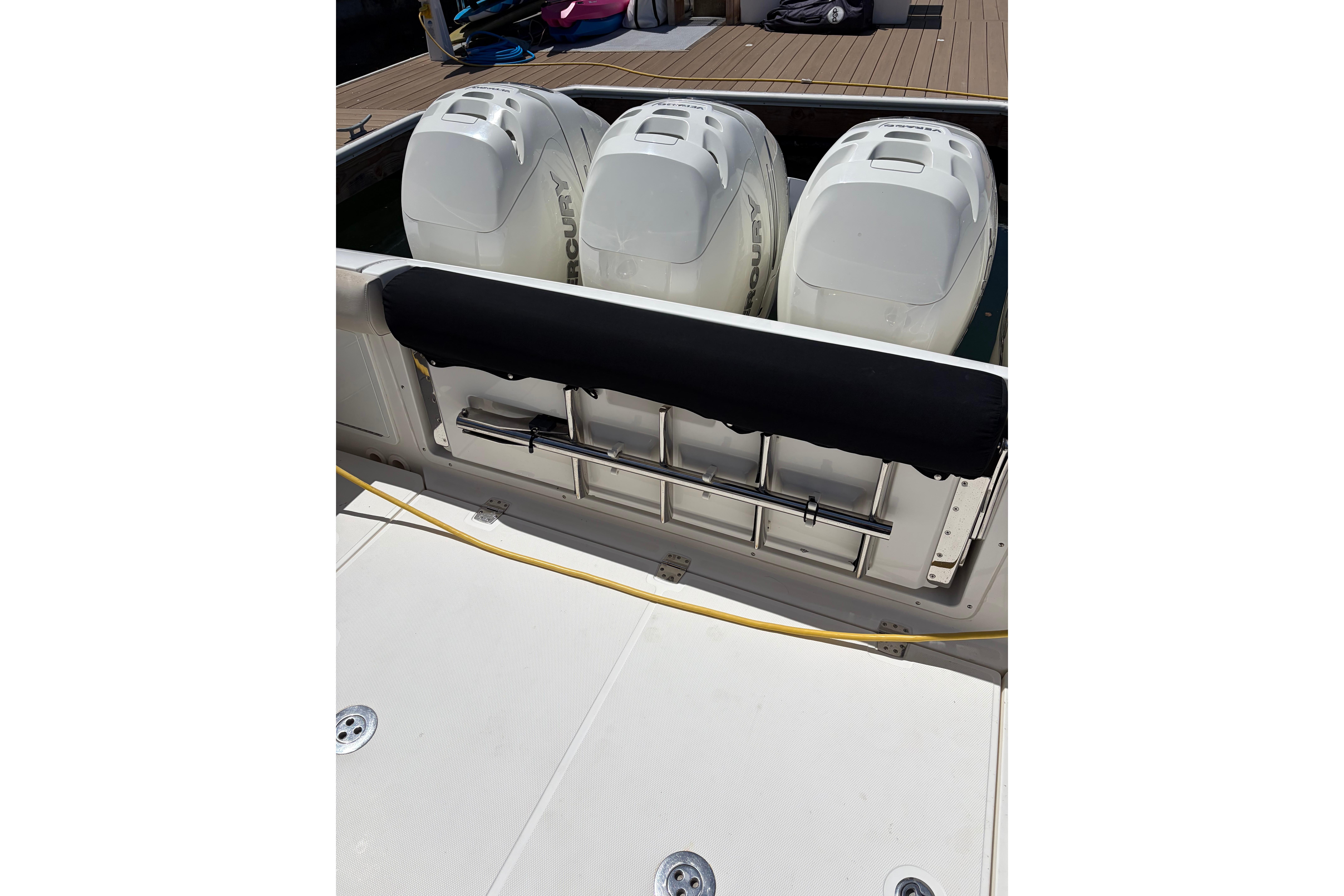 Triple Mercury outboard engines on a 2020 Boston Whaler 380 Realm boat at dock.