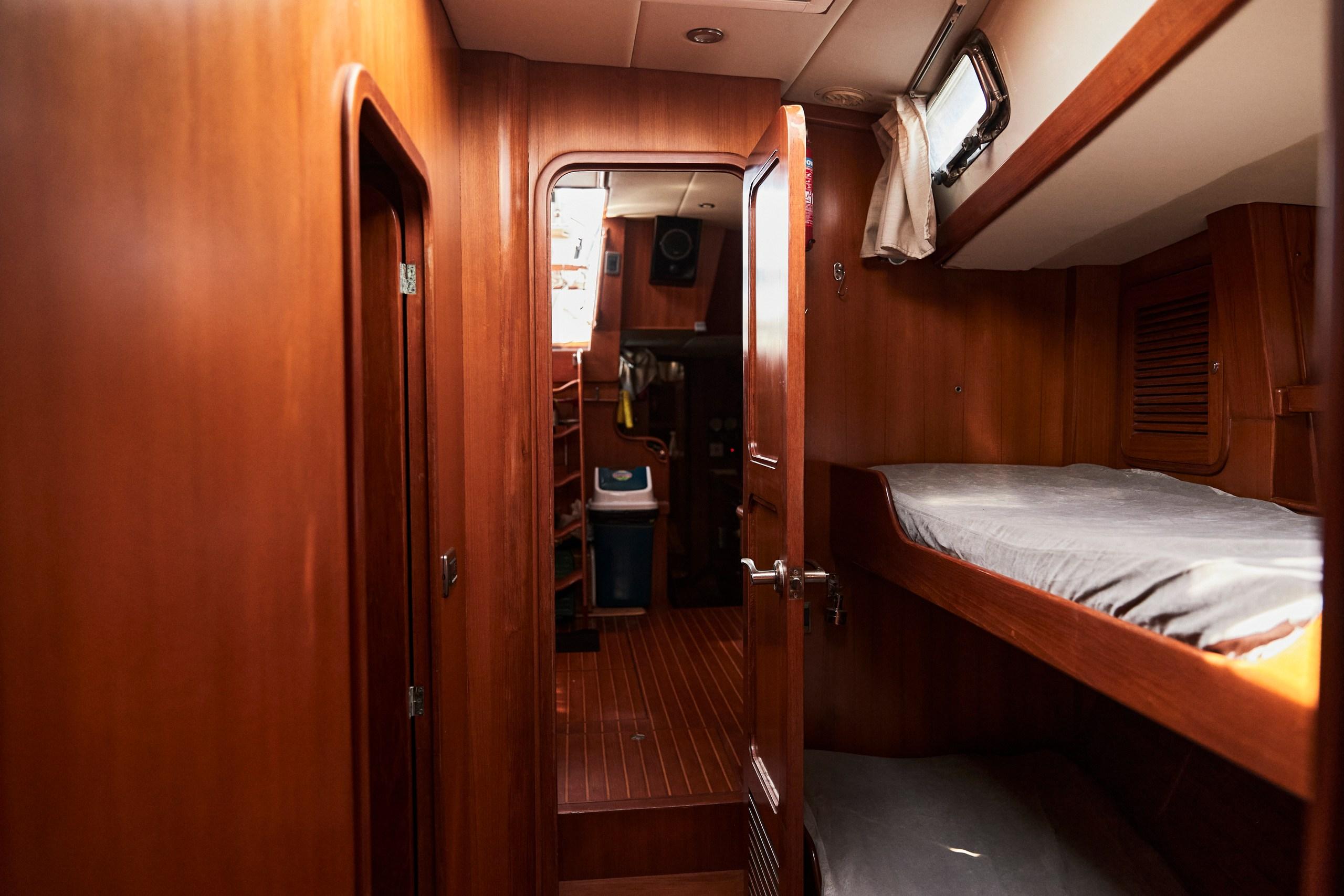Interior of 2008 Tayana 58 yacht with wooden finish and bunk beds.