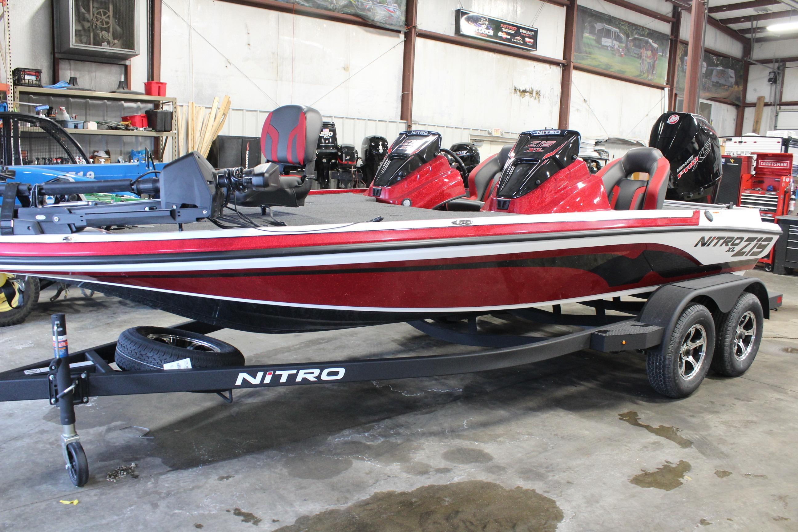 2026 Nitro Z19 XL Pro boat in showroom, red and black design, on trailer.
