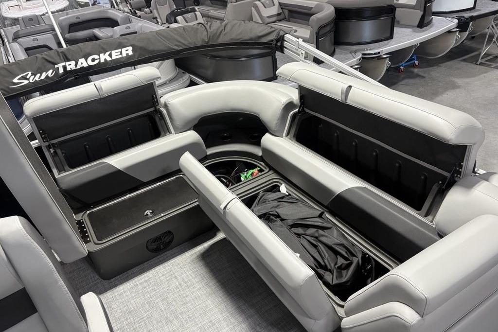 2026 Sun Tracker PARTY BARGE® 20 DLX interior with open storage compartments and seating.