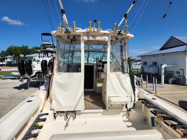 2005 Pursuit 3070 Offshore Center Console boat docked under clear blue sky.